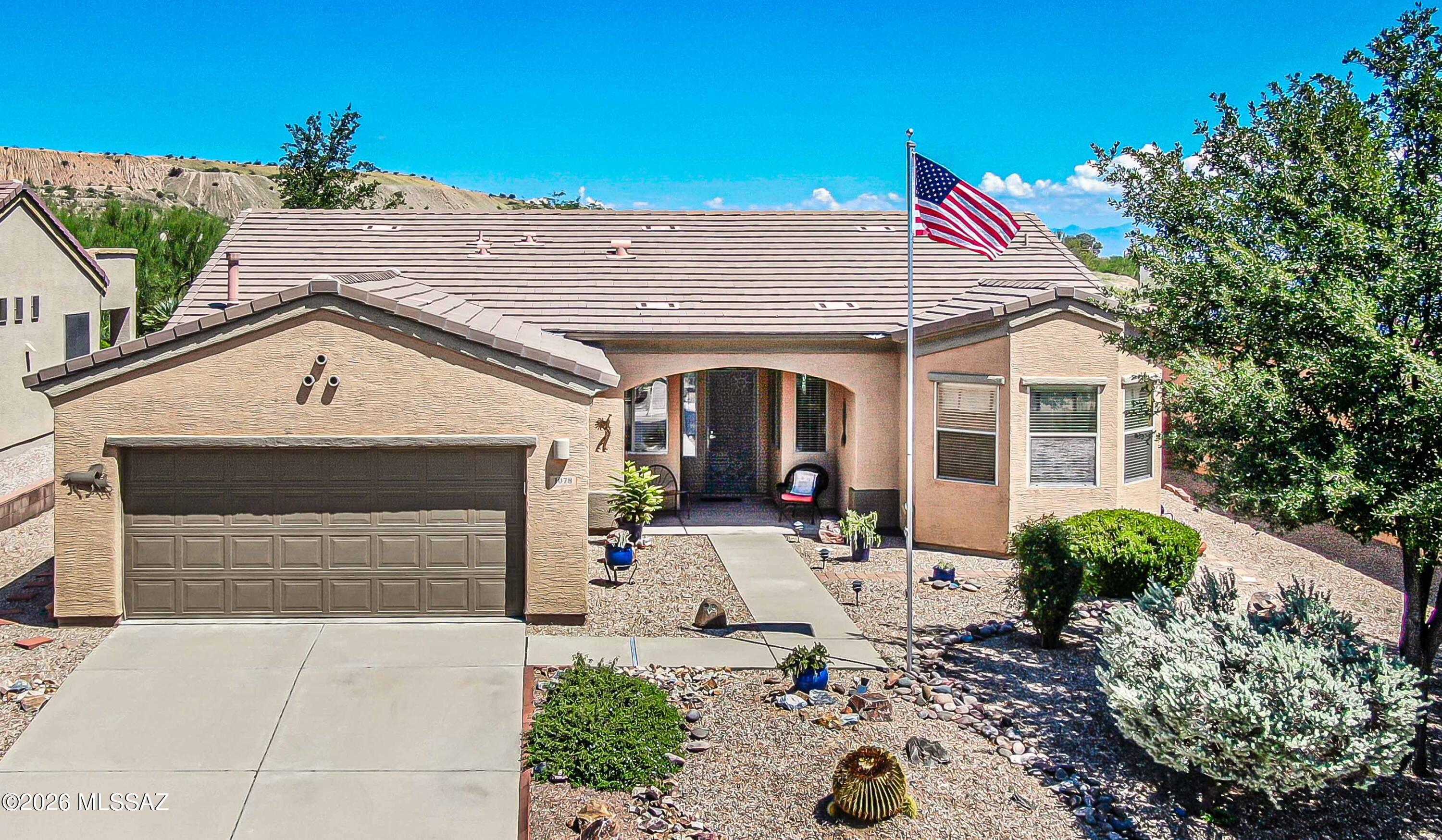 Beautifully maintained Las Campanas home featuring an open great room floor plan and welcoming front entry. Includes 2 bedrooms, 2 baths, a den, hobby area, laundry room, and an oversized 2-car garage with built-in storage cabinets. Interior highlights include bay windows, tile and carpet flooring, Corian countertops, oak cabinetry, a beehive fireplace, custom paint, and ceiling fans throughout. The back patio borders natural desert HOA common area, offering privacy and an ideal setting for outdoor entertaining. A well-appointed home in a sought-after community. Some furniture is included. Must See.
