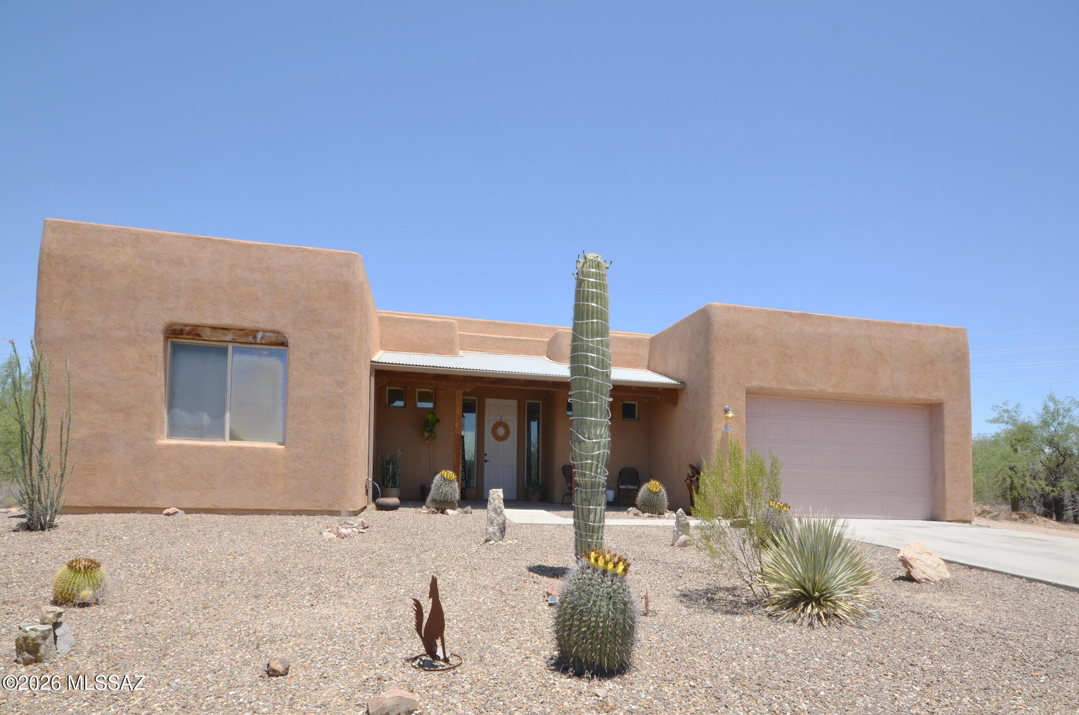 Spacious open floor plan with great room off kitchen, Large room next to kitchen can be a pantry or office.  3 bedrooms split floorplan with a Den.  Walk in shower in master bedroom with large soaking tub and walk in closet.  Enjoy 1.3 plus acre with a basketball slab and plenty of room for many outdoor ideas and outdoor toys.  Enjoy mountain views with stunning sunsets and sunrise in enclosed courtyard in back patio.  Property is connected to city sewer no septic.