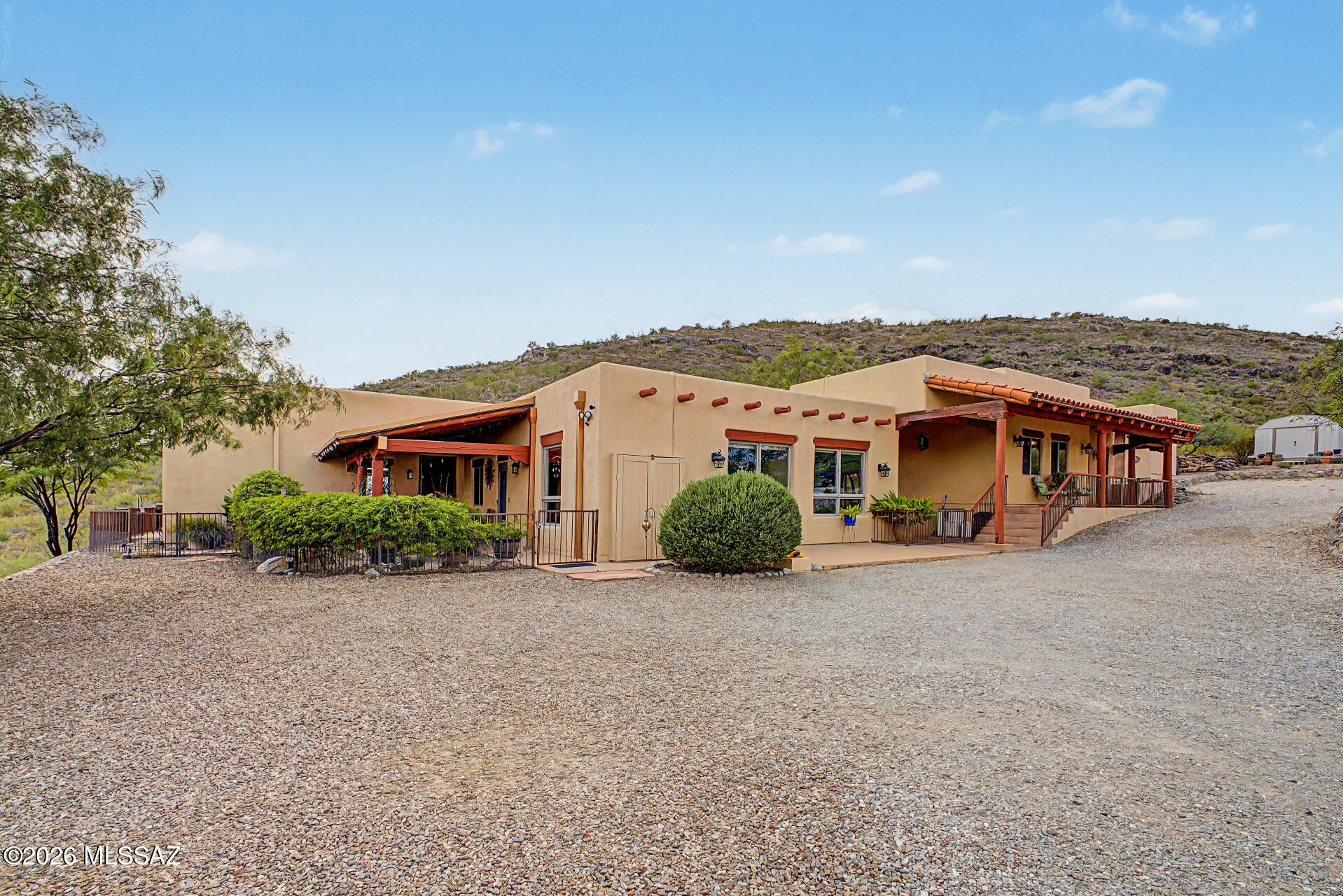 Enjoy peaceful, private living without sacrificing convenience! Set against breathtaking mountain views, this beautifully maintained property is just five minutes from Safeway, Starbucks, dining, and everyday essentials. The 3-bedroom, 2-bath main home features an open floor plan with dramatic ceiling beams, a beehive fireplace, and a well-appointed kitchen with granite countertops, stainless steel appliances, skylights, and a breakfast-bar island. A fully equipped 1-bedroom, 1-bath guest home offers privacy for multigenerational living or extended stays. Additional features include a private well, detached 3-car garage with workshop, and covered RV parking. The perfect blend of space, privacy, and accessibility! Enjoy mountain views from the spacious backyard complete with a covered patio, storage shed, and workshop. This one-of-a-kind gem is the one!