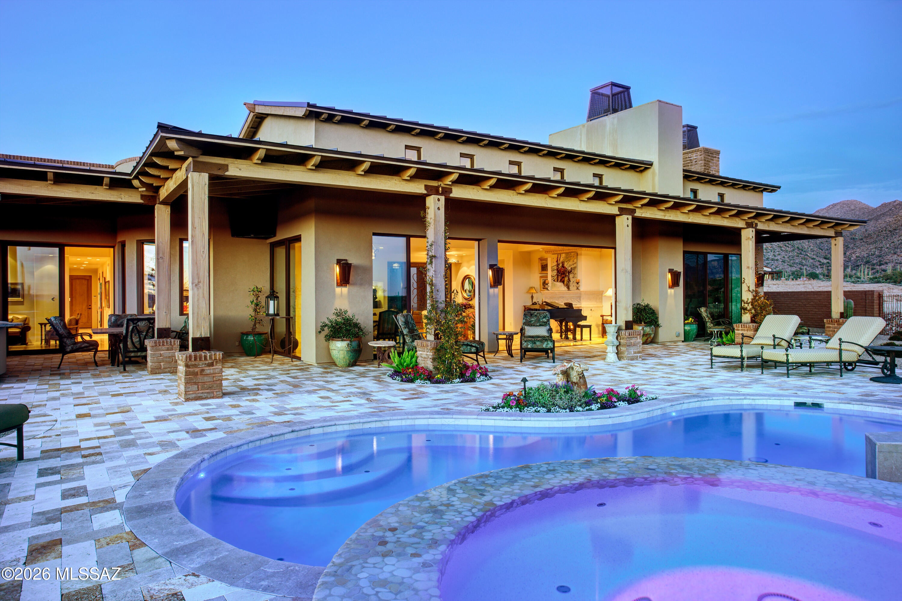 Welcome to The Ritz-Carlton Residences, Dove Mountain. Perched on the most coveted homesite in the community, this exquisite estate combines a timeless main residence with a private guest house, designed to capture sweeping views of the surrounding mountains, golf course, city lights, and both sunrise & sunset. 

The Main House offers all ensuite bedrooms, a versatile den, soaring ceilings, a chef's kitchen, and a custom bar space. Designer, luxury finishes throughout create a seamless blend of elegance and modern convenience. 

The outdoor spaces rival the beauty of a five-star resort. Lush, meticulously designed gardens and vibrant desert landscaping surround a sparkling pool, spa, and outdoor kitchen - offering an inviting backdrop to both quiet retreats and lively gatherings. Owners enjoy access to resort amenities, concierge services, social events & more.