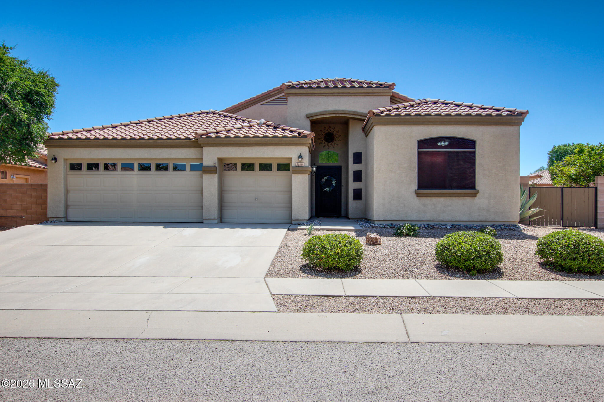Beautifully maintained 4-bedroom, 2-bath home with a desirable split-bedroom floor plan on a premium corner lot backing to a common area. Enjoy Arizona living in the backyard oasis featuring a saltwater pool with waterfall, large grassy area, and citrus trees. Spacious kitchen offers granite countertops, stainless steel appliances, a large island with breakfast bar, and new refrigerator. Fresh interior paint and new carpet in the bedrooms add a move-in-ready touch. The primary suite includes a walk-in closet, dual vanities, soaking tub, and separate walk-in shower. Tile flooring runs through the main living areas. Additional highlights include new water heater, 3-car garage, and a prime location in the highly desirable Vail School District near shopping, dining, and everyday conveniences.