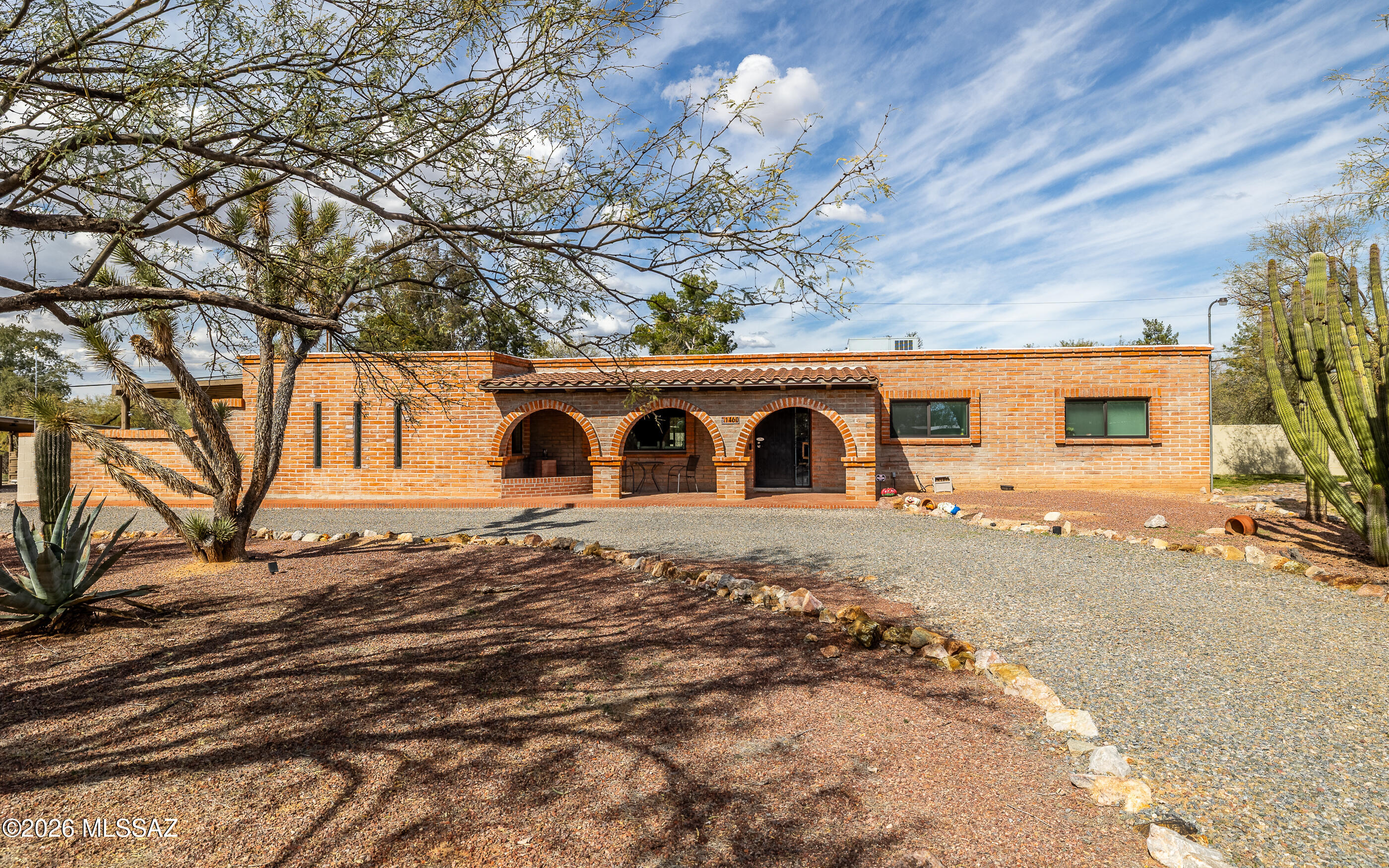 Welcome to this exceptional Mesaland property located in the Amphitheater School District, offering space, flexibility, and beautiful Catalina Mountain views. Set on 1.23 acres with sweeping views of Pusch Peak. The main residence offers 2,985.5 square feet of living space with 3 bedrooms and 2 full bathrooms, plus two bonus rooms currently used as an additional bedroom and an exercise room. This flexible layout is ideal for guests, home office space, or multi generational living. A spacious family room with a wood burning fireplace creates a warm gathering space, while the open concept kitchen flows seamlessly into the main living areas, perfect for everyday living and entertaining.Additional interior highlights include a de