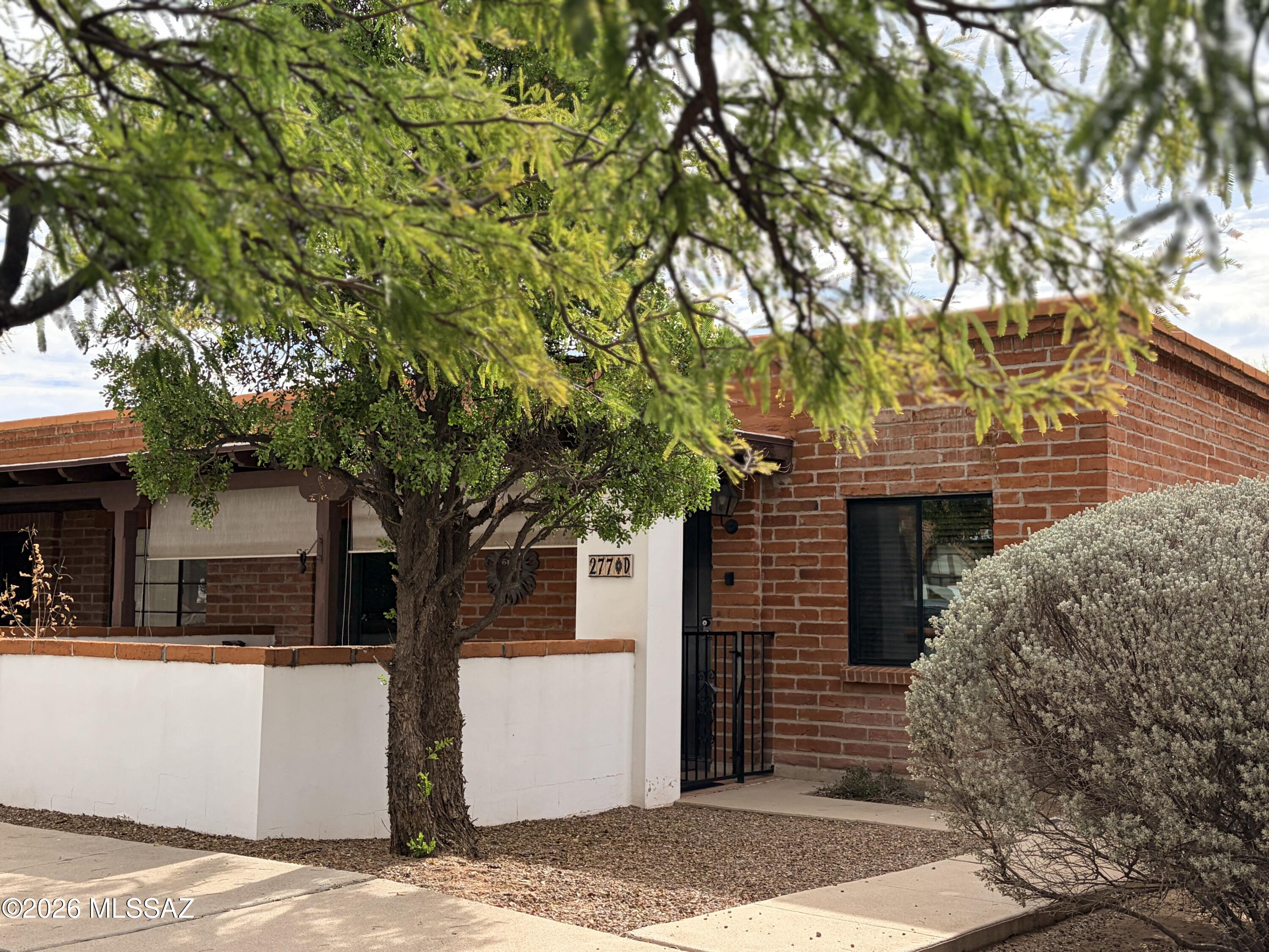 Nicely upgraded with new windows, tiled tub/shower with glass doors, 36'' vanity, mirrored closet doors in both bedrooms.  The kitchen has full size refrigerator, apartment size gas stove and a dishwasher.   Best of all, a washer/dryer is conveniently located just out the back door in the added storage shed with shelving.   Enjoy this end unit on a corner lot with easy care tile floors throughout!   A great price for all the upgrades!   And NO GVR....but available.