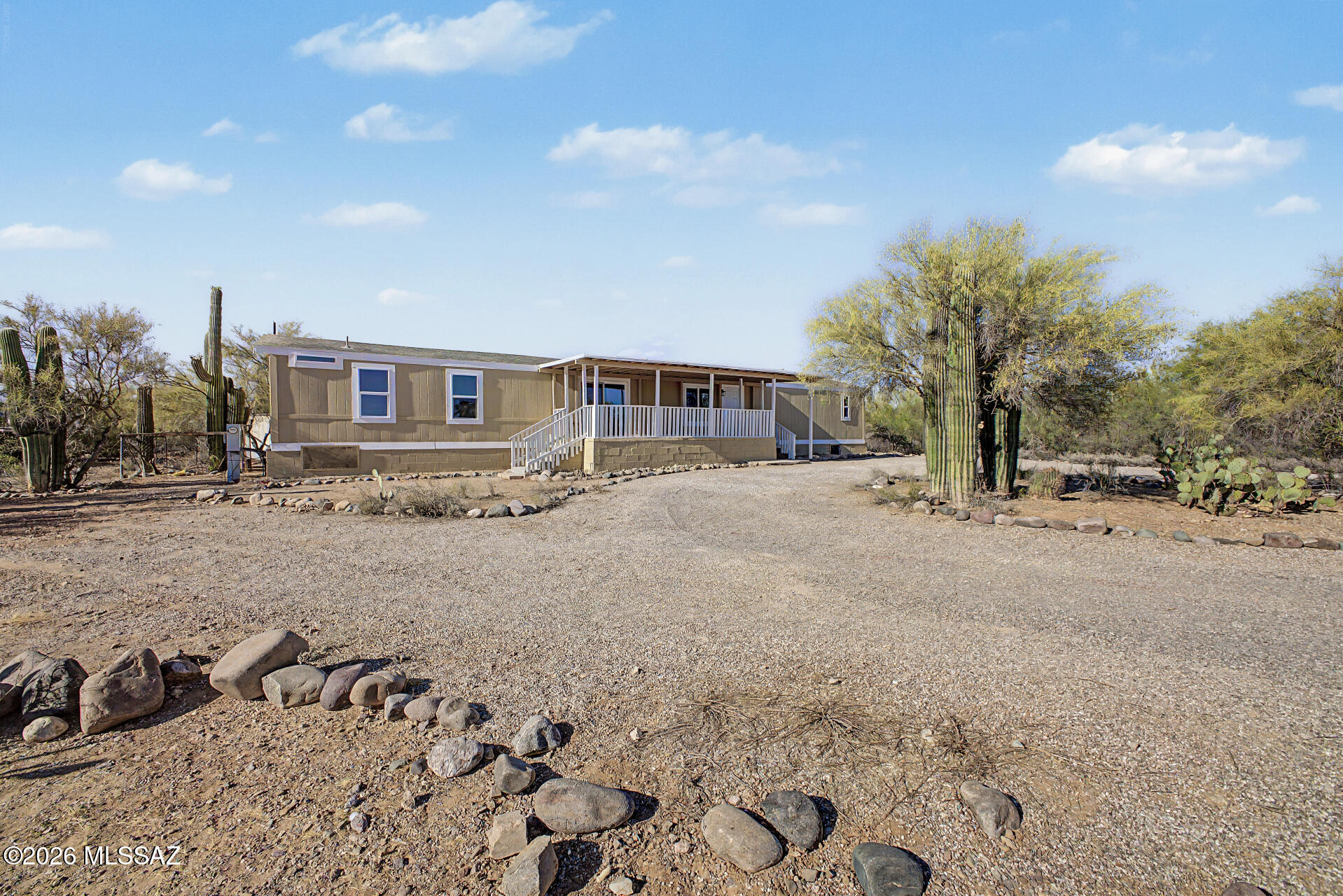 Seller to accept or counter $249,900-$259,900.Magnificent fully remodeled manufactured home on a sprawling acre of peaceful desert landscape! This move-in ready retreat blends modern style with serene Arizona living, featuring tasteful upgrades throughout and an inviting open layout filled with natural light. Step outside to an amazing oversized deck perfect for enjoying breathtaking desert views, colorful sunsets, and beautiful weather year-round. Plenty of space to relax, entertain, or create your dream outdoor oasis. Conveniently located close to shopping, dining, and everyday amenities while still offering the privacy and tranquility of country-style living. A rare opportunity to enjoy the best of both worlds!