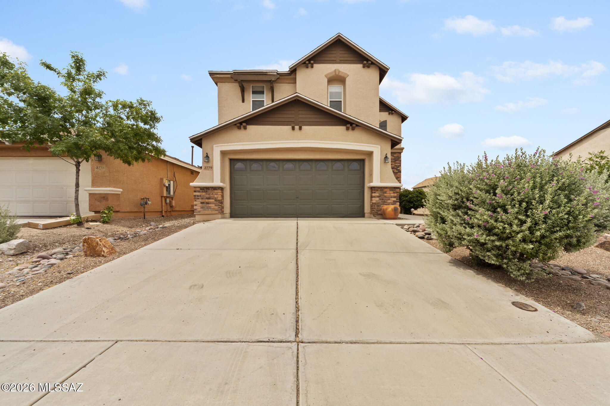 Seller will contribute $5,000 towards buyer's closing costs with an acceptable offer.  Sitting on a corner lot Mariposa Trail, 2779 W Greenstreak Drive offers residents a neighborhood setting close to many conveniences. This property features 2023 sq ft over two stories. The ground level includes a spacious kitchen and great room, plus a powder room, laundry room and large storage closet. The upper level includes 3 bedrooms, 2 bathrooms, plus a huge bonus room. The interior has been freshly painted, creating a light and bright aesthetic throughout. Outdoors, the backyard has been nicely finished with a spacious covered patio, outdoor kitchen, concrete for easy maintenance and pops of green from fruit trees and desert plantings. Inside the neighborhood, there is a community park. From this location, there is near immediate access to I-10 for commuting and Northwest Medical Center sits 5 minutes away. Access to "The Loop" multi-use paved path for cycling, walking or running is immediately south off River Rd. Within a 10-minute radius, there is everything that you could need: grocery stores, medical offices, Costco, schools, restaurants and retail.