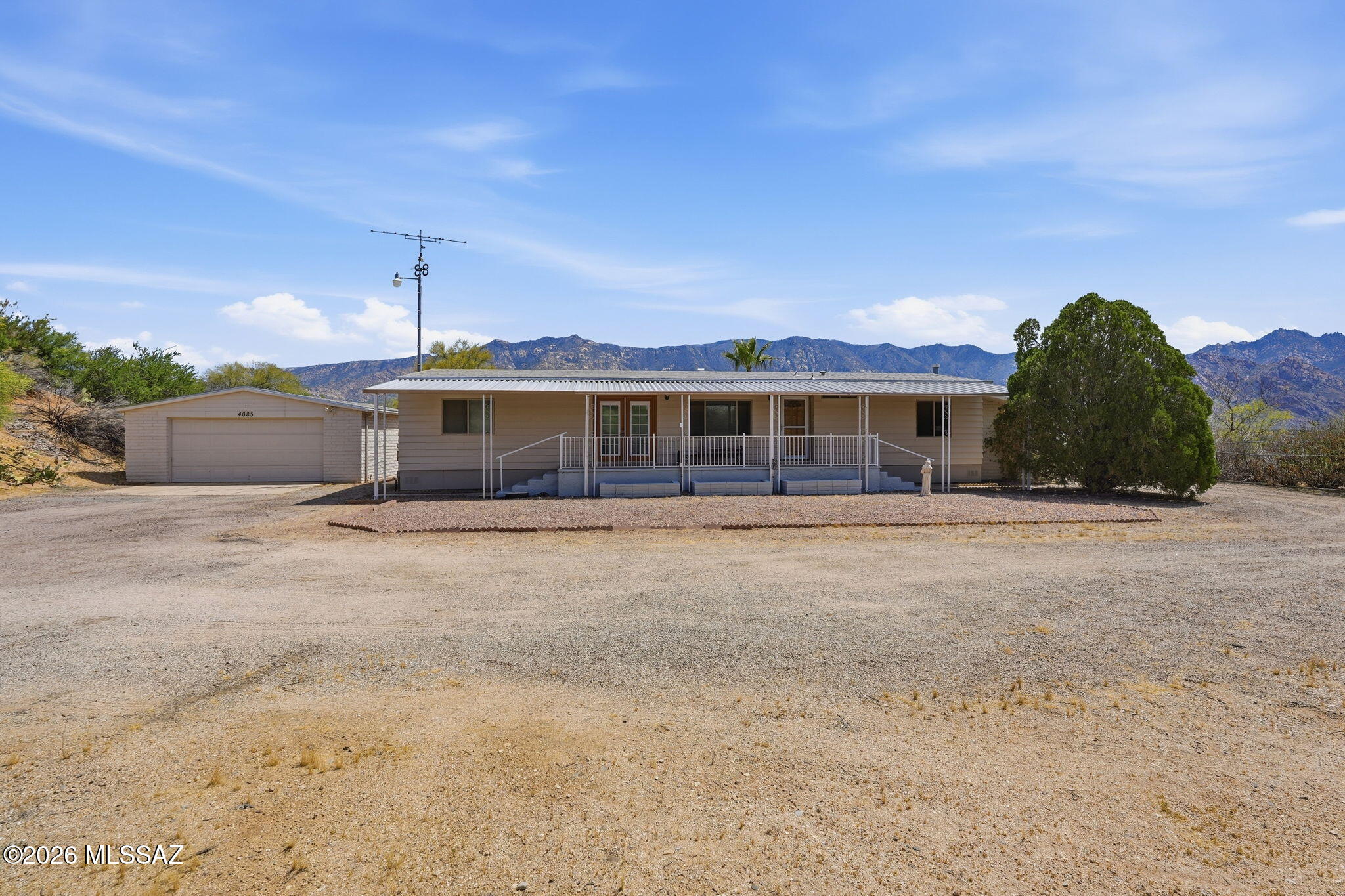Breathtaking east-facing Catalina Mountain views & total privacy define this inviting home on 1.2 private acres. Unique 160 Sqft concrete block basement ideal for storage or cool living space, the property includes a spacious 3-car garage/space for workshop w/ 220 electric. Inside, enjoy an updated primary bathroom featuring an upgraded walk-in shower, a remodeled kitchen, dining area & a large living room perfect for relaxation & entertainment. Laundry room with extra storage. The thoughtful split floor plan offers comfort & separation. Step outside to covered front and back patios ideal for outdoor living. Additional features include chain link fencing, RV parking & a corral. Upgrades consist of Pex pipes, new roof 2023, new septic 2023, HVAC 2018 & water heater 2019.