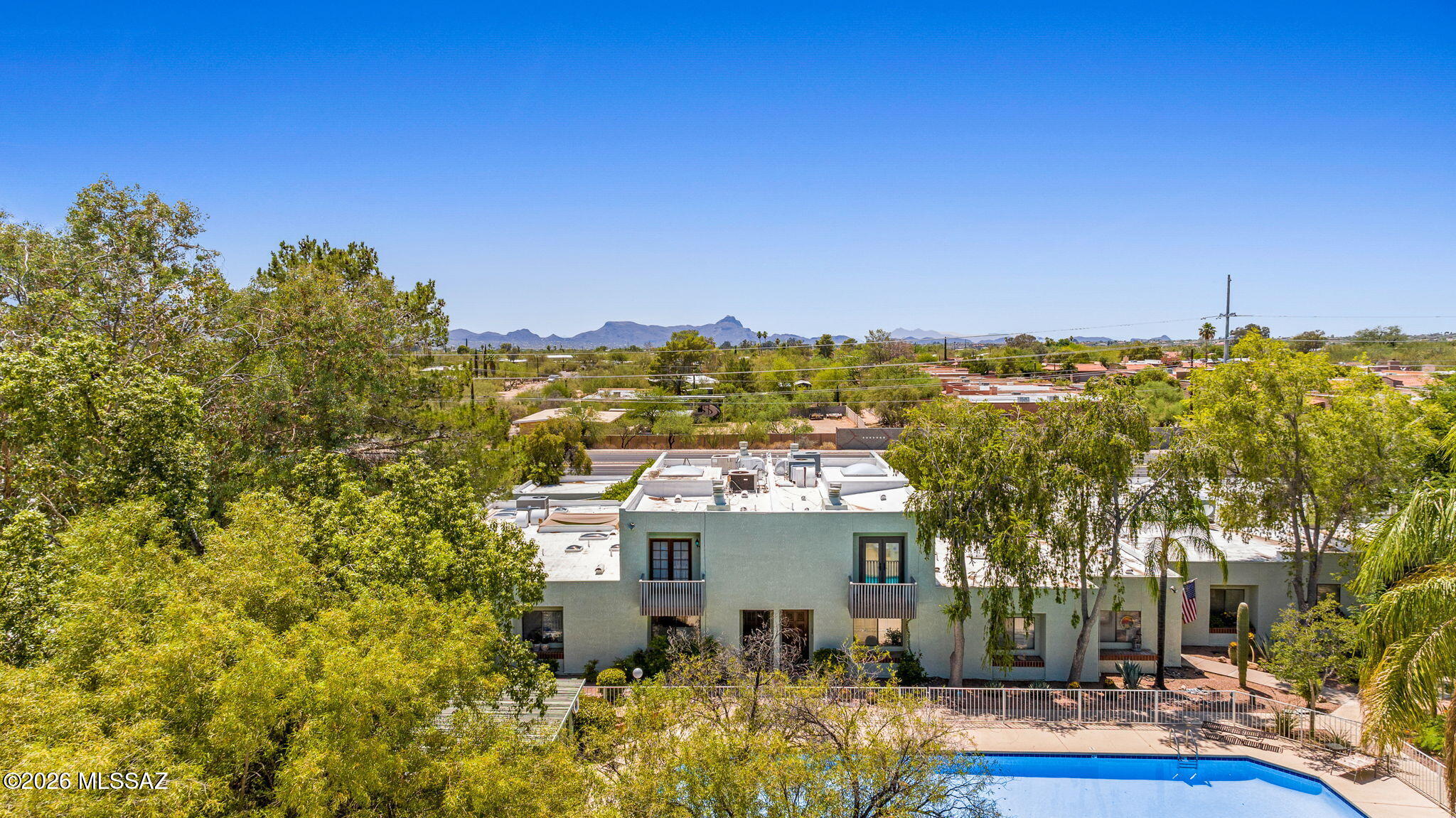 This Tucson Townhome is a 2 story, 2 bed, 2 &1/2 bath charmer. The Primary's bedroom window looks out over the heated pool, with a stunning mountain backdrop.only minutes away from shopping, trails and Tohono Chul Botanical Gardens. The grounds of the gated common areas are the kind that will take you away to an enchanted courtyard. Every home owner has their own two-car garage, plujs ample guest parking in the visitors lot. Inside you'll find a spacious 2 story layout built for entertaining, note the center atrium with indoor builtin planters, featuring lovely and mature tropical greenery. A warm mix of earth tones and wood make for a relaxing atmosphere. The two bedrooms upstairs are equipped with wood burning fireplaces. Come and see it in person!