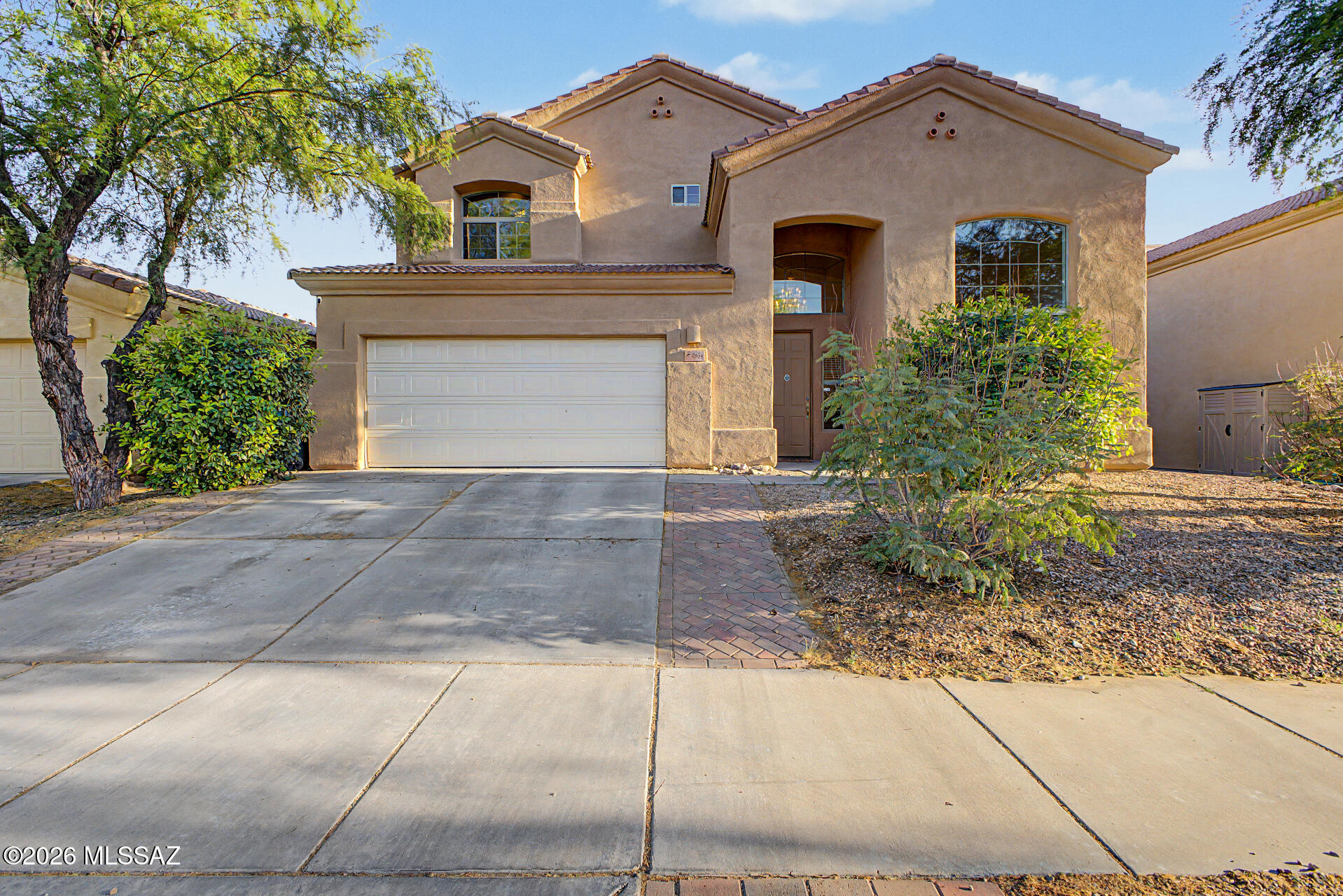 Both HVAC systems are brand new! This expansive 5-bedroom, 3-bath home offers a flexible layout designed to fit a variety of lifestyles. A bright, open interior welcomes you with soaring vaulted ceilings and generous living areas filled with natural light. The main level includes two bedrooms and a full bathroom, ideal for multi-generational living, a home office, craft room, or fitness space. The adjacent living room and separate family room create a comfortable setting for everyday living and gatherings. The open-concept kitchen is both functional and inviting, featuring granite countertops, stainless steel appliances, a large island with breakfast bar, and a cozy dining nook. Upstairs you'll find two additional guest bedrooms with full bath, and a generous primary suite that provides a private retreat with its own covered balcony and a well-appointed en-suite bathroom complete with dual vanities, a soaking tub, separate shower, and a large walk-in closet. Step outside to an oversized backyard that has been newly landscaped with extended pavers, a relaxing covered patio, raised flower beds, mature trees, low-maintenance artificial turf, back walls that have been raised for added privacy, and a back gate installed for direct access to the park. With over $30,000 in upgrades and improvements by the current owners, this move-in ready home offers comfort, space, and convenience with close proximity to Vail District schools, a wide variety of shopping and dining destinations, easy I-10 access, and only 7 miles from Davis-Monthan's South Wilmot Gate. This home truly has it all! Other updates; upstairs AC (June 2024) downstairs AC (May 2026), new larger kitchen sink with new garbage disposal and faucet, static window privacy screens, living room floor from carpet to vinyl, master bedroom screen door installed, hose reel wall attachment for backyard water supply, reverse osmosis system in kitchen (2026), irrigation system updated (2025), new microwave (2026), carbon monoxide alarm installed, new washer and dryer (2024), doggy door installed (2025).