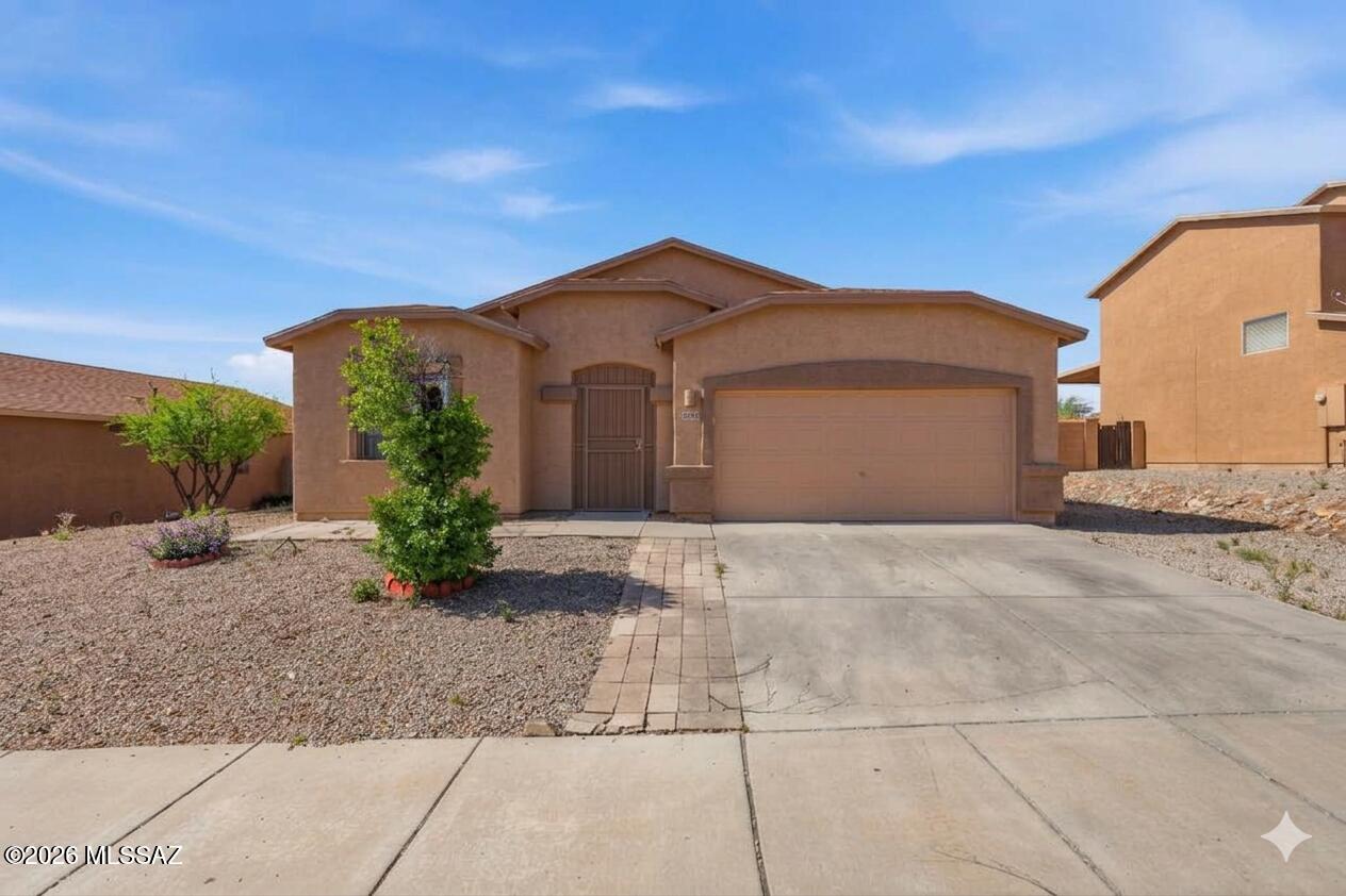 PACK YOUR BAGS AND CALL THE MOVERS, THIS HOME IS MOVE IN READY! BRAND NEW ROOF, BRAND NEW CARPET AND FRESHLY PAINTED ON BOTH INTERIOR AND EXTERIOR. This charming 3 bedroom, 2 bath home on Tucson's SW side features an open floor plan perfect for entertaining. The spacious kitchen boasts a central island ideal for conversations with the cook, and gatherings. Enjoy a beautiful backyard with lush turf grass, citrus trees, an extended covered patio, and breathtaking mountain views,with no neighbor behind you. Perfect for relaxing under star-lit desert skies. This home offers quick access to the interstate, making commuting a breeze. A true desert gem with both comfort and convenience! Community pool, w/basketball court, sand volleyball, and a park-like setting with ramadas. Don't miss this one