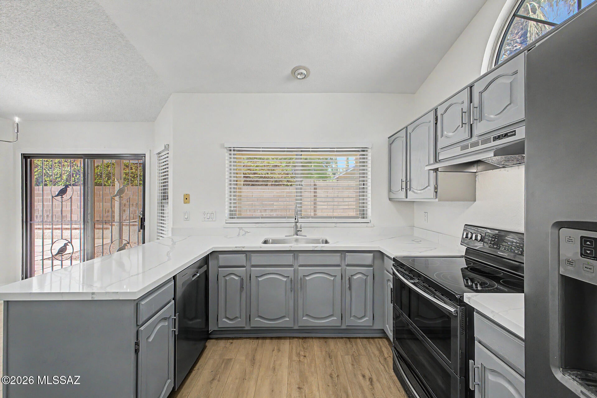 Do not miss this fantastic move-in-ready home! This gem features a great curb appeal, an easy-care landscape, and a 2-car garage. Inside, you'll be charmed by the thoughtfully designed living areas showcasing new LVP flooring, soaring vaulted ceilings promoting a feeling of openness, a fireplace perfect for chilly evenings, and a soothing palette that makes you want to stay. The kitchen comes equipped with ample cabinetry,  quartz counter tops, and recently updated appliances to make home cooking a breeze. Get a good night's rest in the main retreat, complete with a walk-in closet and a full bathroom with dual sinks. The backyard includes a covered patio ideal for morning coffee and a nice seating space for outdoor fun. Hurry up, this gem won't last! AC and Roof are less than 5 years old.