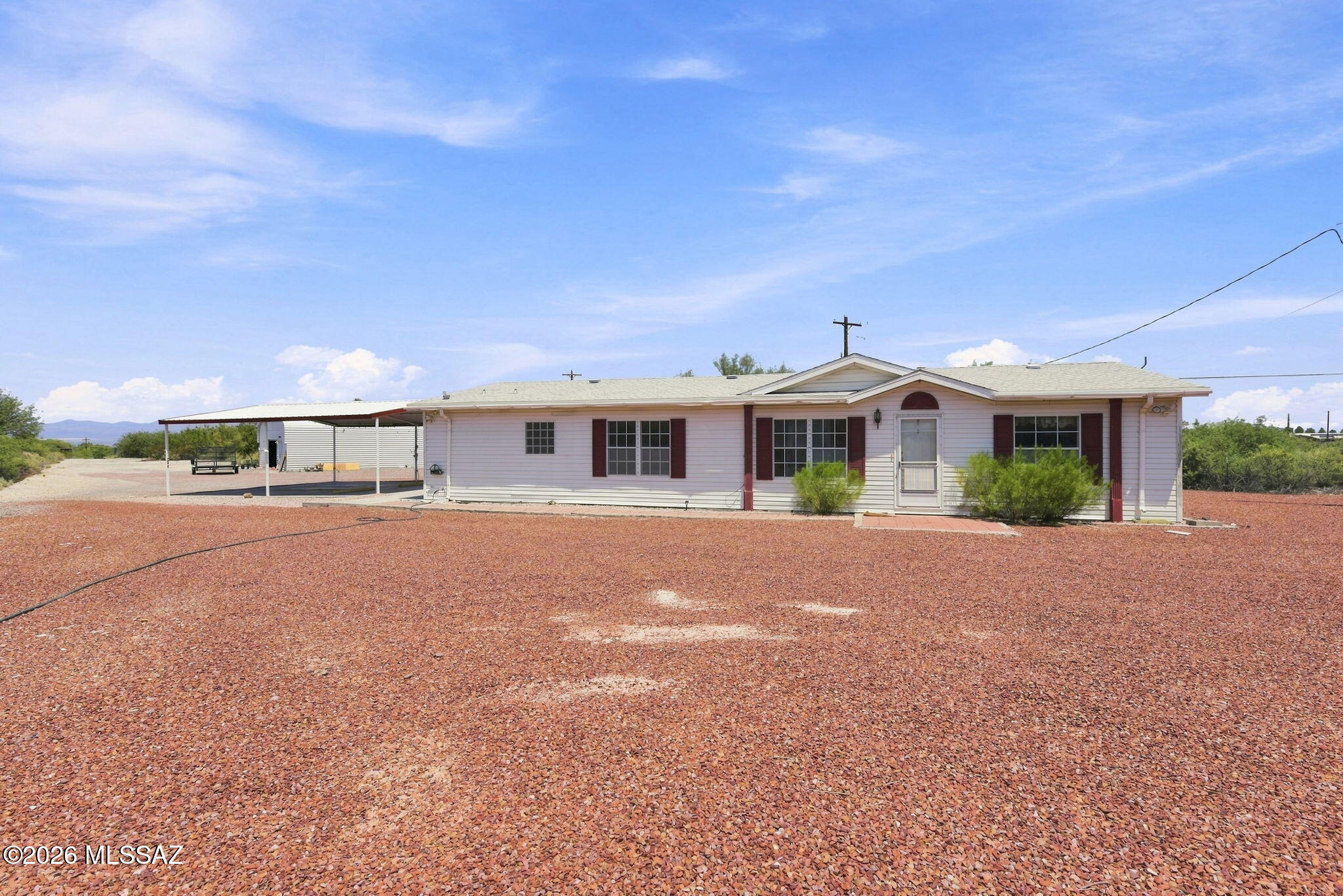This spacious 1,554 sq. ft. manufactured home offers 3 bedrooms and 2 bathrooms, complete with an additional dwelling unit (ADU) and a large shop featuring an office. Located on over 6 acres of land, it features up-close views of Mount Graham and is conveniently located next to Katchina Mineral Spa and Spring. If you're looking for space and potential, this property is ideal. The main house includes two living areas, a water filtration system, and a covered back porch. Outside, you'll find a hot tub, a spacious two-car carport with room for expansion. The property is equipped with a well, an irrigation well, and two septic tanks. The expansive shop offers ample storage and includes a built-in office. Additional features include a shed, a dedicated RV spot with connections, and a pad for an above-ground pool. The ADU is in excellent condition, complemented by a reverse osmosis system, presenting a potential income opportunity. Don't miss the chance to make this property your own!