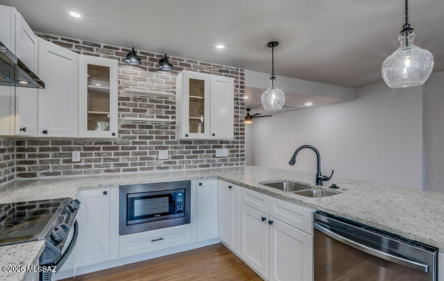 Updated home with the character and charm of the 1940 Blenman bungalow retained. The open design offers comfort and style across approximately 1626 sqft of thoughtfully designed living space. It features engineered wood flooring in public areas, carpet in bedrooms and custom tile accents in the stunning bathrooms. The redesigned kitchen is enhanced with a brick backsplash, granite counter tops, shaker style cabinets, SS appliances and stylish lighting. French doors lead out to the covered back patio and turf yard. The spacious primary suite has an updated bathroom but the look of the 1940's. Location, location, location! Blenman Elm Historic District... convenient to the U of A, Banner Medical Center and downtown. Close to parks, restaurants and other central hotspots. Large .23-acre lot with home positioned on the lot perfectly to add an ADU.
