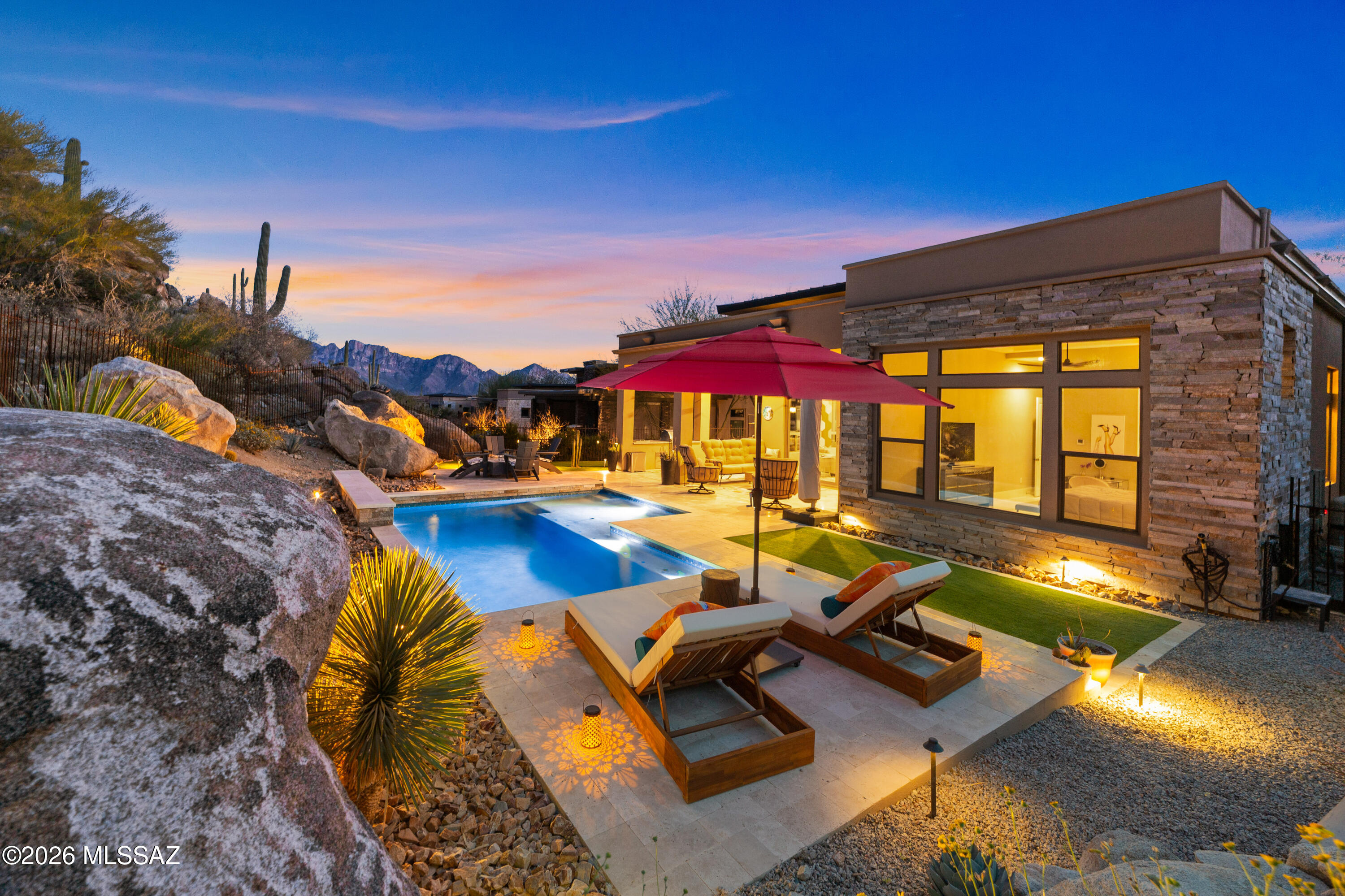 Come home to refined desert luxury in the exclusive Boulder Vista enclave within Stone Canyon. Set on a private cul-de-sac among just 36 half-acre homesites, this 2,751sf home captures breathtaking Catalina Mountain vistas, dramatic boulder outcroppings & the serene beauty of the high desert. This thoughtfully designed 3BR/3½BA home w/dedicated office & formal dining area blends elegance with effortless indoor-outdoor living. Dining area sparkles beneath a crystal chandelier & opens to a stunning, wine room complete with granite counters, tile surround, built-ins, beverage cooler & designer lighting. Gourmet kitchen is a true showpiece featuring premium cabinetry w/pull-outs & accent lighting, quartz and granite surfaces & professional KitchenAid appliance suite including a 6-burner gas cooktop, double wall ovens, microwave/convection oven &  built-in French door refrigerator. Oversized island w/farmhouse sink & bar seating anchors the space, making it perfect for entertaining. Spacious great room opens through dual sliders to backyard that truly steals the show. This private resort retreat features a sparkling PebbleTec pool w/lagoon shelf & in-floor cleaning system, travertine patios, built-in Lynx BBQ, gas firepit, & professional landscape lighting that illuminates towering saguaros & natural boulders at night. The tanning shelf faces directly toward the Catalina Mountains a daily reminder of why this setting is so extraordinary. Primary suite offers mountain views, motorized window coverings, custom oversized walk-in shower w/rain head & push-button controls & beautifully designed California Closet system. Each guest bedroom enjoys its own private ensuite w/quartz counters & floor-to-ceiling tile showers. Additional highlights include owned 26-panel solar system, solar pool heating, motorized rolling shutters, 24" porcelain tile floors, EV charger outlet, brick paver driveway & low-care landscaping on drip system.

Residents enjoy membership at the exclusive Stone Canyon Club with access to the championship golf course, luxurious fitness facilities, tennis, pickleball and restaurant.

If you've been waiting for privacy, views, and true resort-style living in Oro Valley, this is the one!