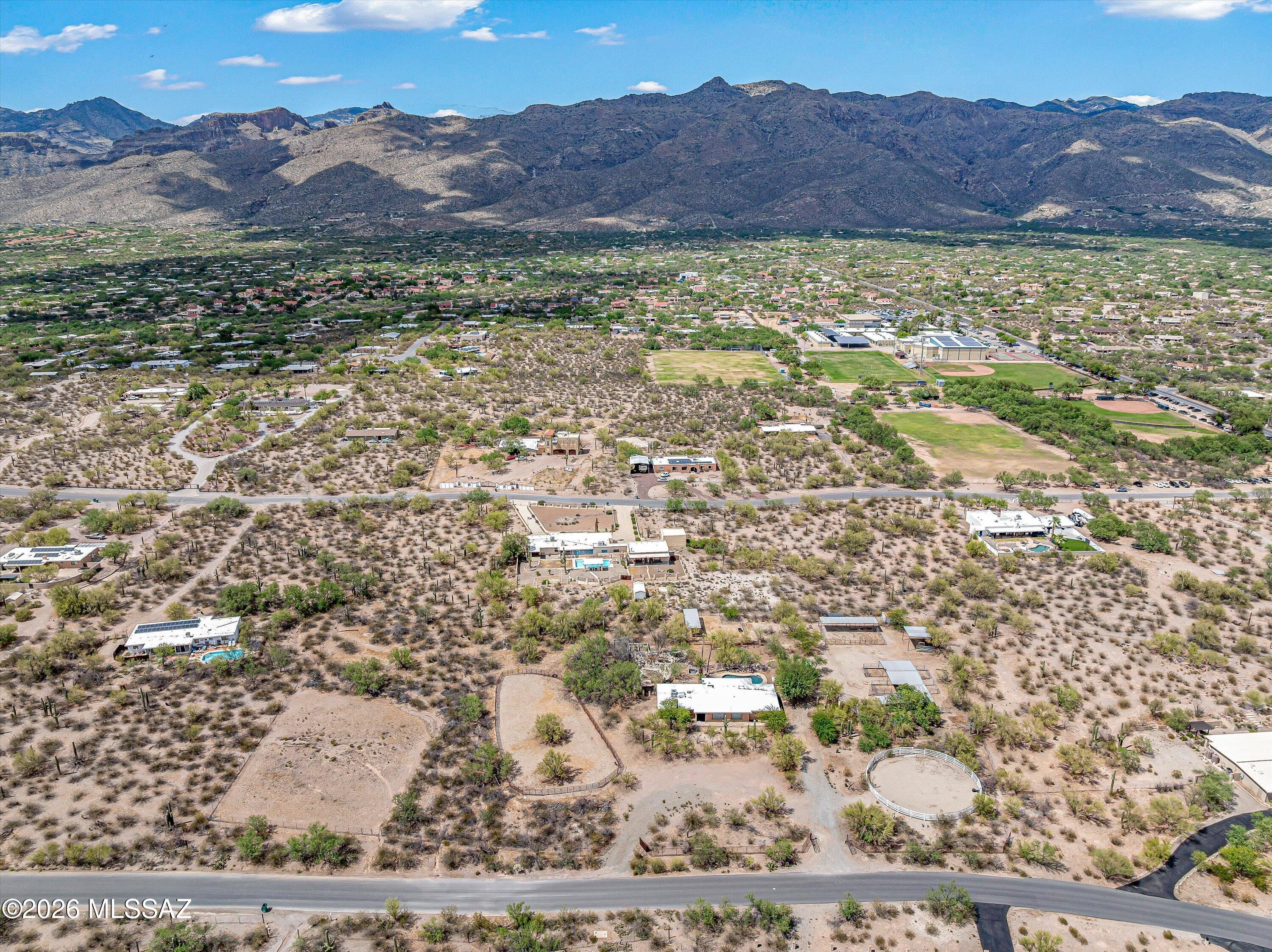 Rare estate sale opportunity for an affordable 3.37 acre equestrian property with panoramic backdrop of both Catalina and Rincon Mtns!  Facilities inc. 70-ft diameter round pen, approx. 8,000 sq ft riding arena, (3) separate turnout structures to accommodate 6-12 stalls, 3 storage sheds, high-clearance covered bay and ample room for trailers.  Other outdoor amenities include an inground swimming pool, aviary, chicken coop, dog run, covered brick patio, built-in grilling island and desert-landscaped back yard.  The 4-BR house highlights an updated granite kitchen, masonry fireplace, new carpet and new HVAC.  The property is near Tanque Verde High School and offers easy access from Catalina Hwy, Houghton and Ft. Lowell while sited on a lower-traffic stretch of Roger Rd.