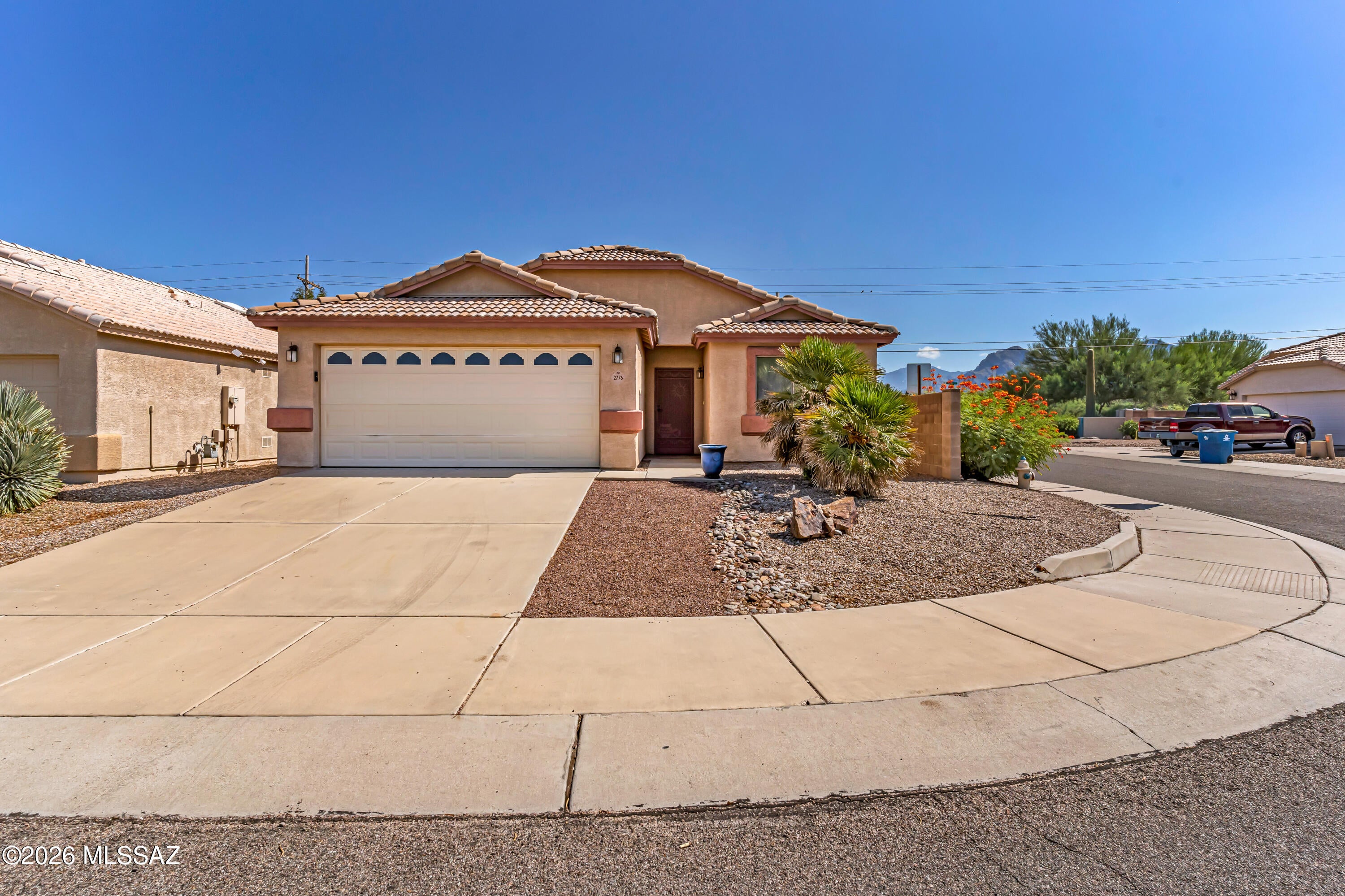 Welcome home to this move-in-ready 3-bedroom, 2-bath home in Northwest Tucson! Freshly painted throughout, this bright and inviting home features an open, versatile floor plan with vaulted ceilings, architectural niches and a large center breakfast bar perfect for entertaining. Solid-surface flooring runs throughout the main living areas and bathrooms, while the spacious primary bedroom offers convenient built-in storage. Step outside to a low-maintenance backyard with mountain views, extensive pavers and a full-length covered patio with ceiling fans, perfect for enjoying Arizona living year-round. Conveniently located near shopping, dining, parks, Pima Community College, YMCA, Omni Tucson National Golf, Northwest Medical Center and more. Clean, comfortable and ready for its next owner!