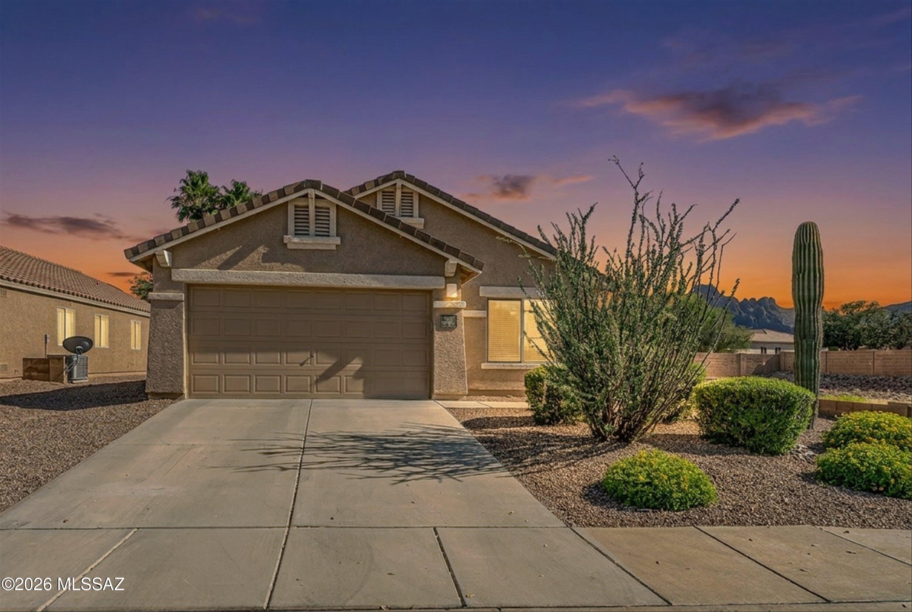 Beautifully maintained 3 bedroom, 2 bathroom home featuring a NEW roof, newer two-stage HVAC system, upgraded flooring, updated kitchen and bathrooms, and an upgraded backyard with newer artificial turf and shade canopy. With no neighbor directly to the west and views of Sombrero Peak from the kitchen, dining room, living room, and backyard, this home offers a rare sense of openness and connection to the desert. (Owner/Agent)

Some of our favorite memories in this home started around the dining room table during family breakfasts, watching hot air balloons drift across the western sky as the sun came up over Tucson. The wash directly to the west creates a sense of openness and privacy while bringing desert wildlife right to your window. Over the years we have watched rabbits hop through the desert, coyotes wander by at dusk, families of javelina pass through, and even the occasional bobcat, all from the comfort of home.

Inside, the vaulted ceilings and open layout create a bright and welcoming feel throughout the home. One of our favorite additions was turning the kitchen nook into a custom dry bar with matching cabinetry, glass cabinet doors, and a wine rack that became the centerpiece for holidays, gatherings, and evenings spent with friends and family.

The backyard became an extension of our living space. The shade canopy and newer Bully Dog artificial turf created the perfect setup for relaxing evenings outside, whether it was enjoying the mountain views or setting up the projector to watch movies and sports under the Tucson sky. Some of our favorite nights were spent outside with family and friends gathered together cheering on games or watching movies late into the evening.

The primary bedroom was recently updated with new luxury vinyl plank flooring, and smart switches throughout most of the home added convenience while preserving the warmth and comfort that made this house feel like home.

This home has given us countless memories, quiet mornings, beautiful sunsets, and a connection to the desert that we will truly miss. We hope the next owner loves living here as much as we have.