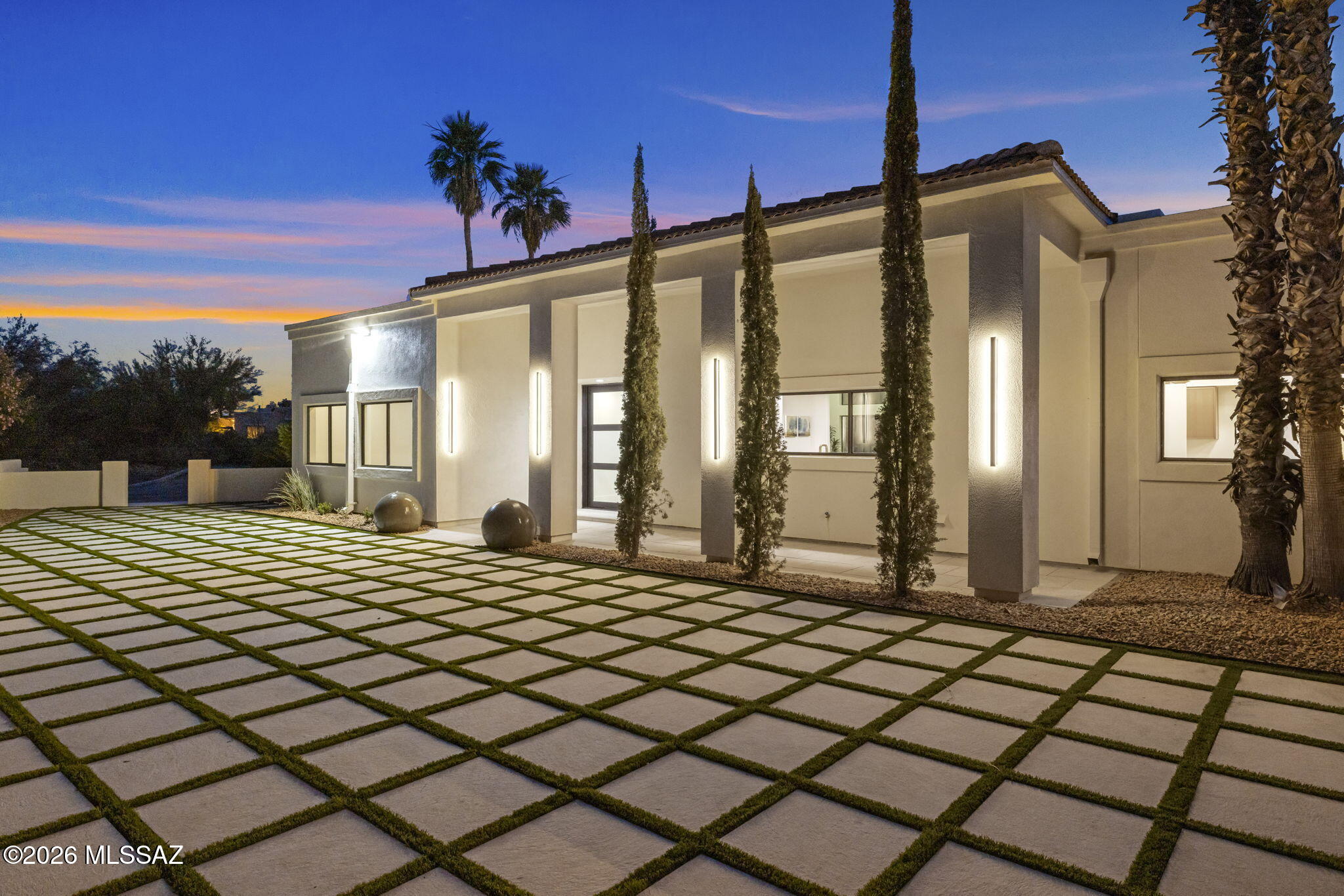 Majestic Oro Valley Country Club Home Perched high on a premium elevated corner lot overlooking the stunning 18th lake hole of Oro Valley Country Club, this fully remodeled masterpiece redefines luxury desert living. With 5 bedrooms, 5 bathrooms, and a large detached guesthouse, this estate offers an exceptional blend of sophistication, space, and versatility.
Step inside to experience a home that has been completely transformed with high-end designer finishes throughout. The heart of the home is a chef's dream kitchen, featuring top-of-the-line Thermador appliances, striking quartzite countertops, custom cabinetry, and expansive prep and entertaining space. Towering ceilings and walls of windows flood the home with natural light while perfectly framing the