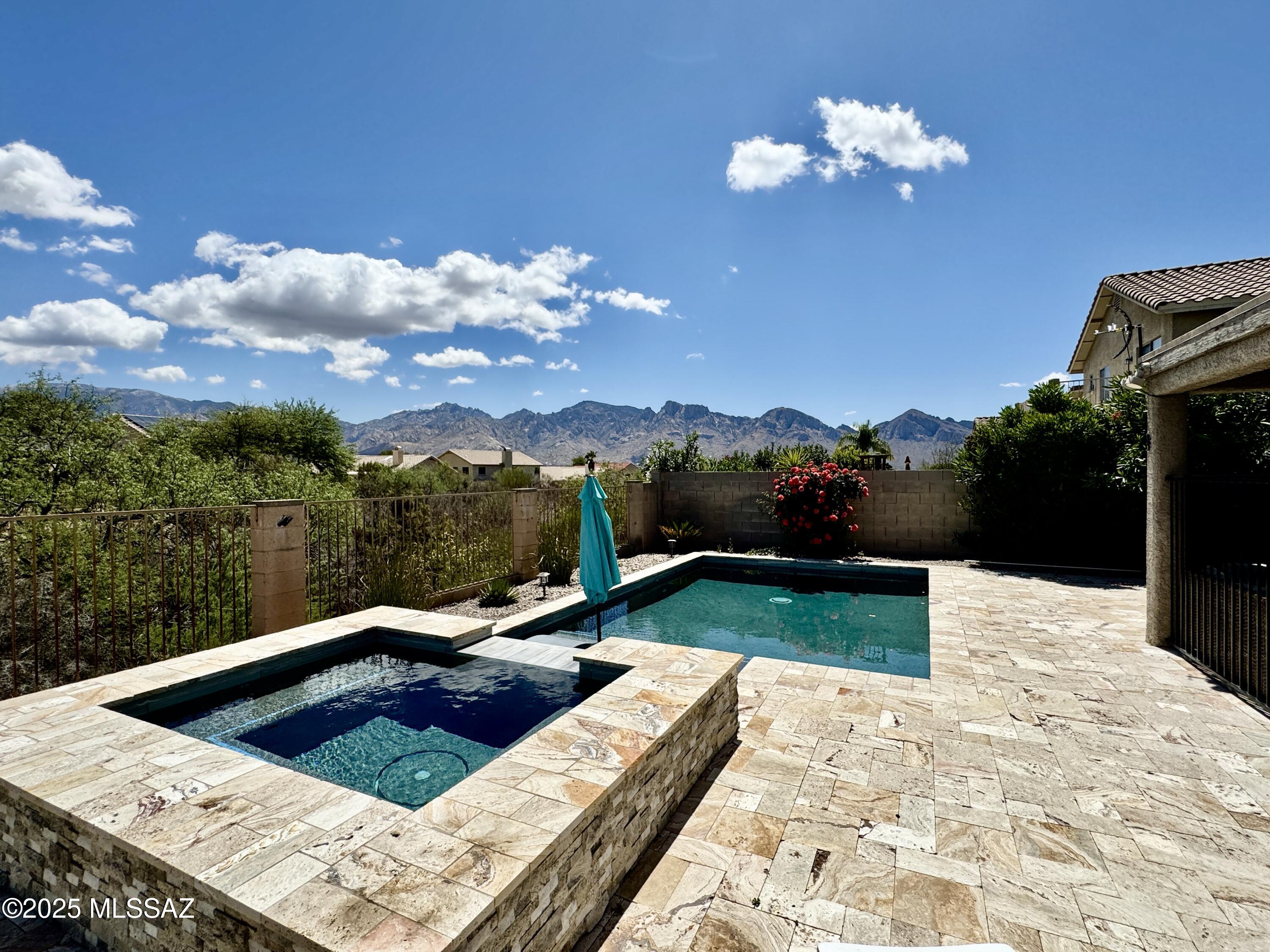 MOVE-IN READY - is a complete understatement - This property would make an awesome Airbnb - with heated pool/spa and spectacular mountain views!

This exquisite 2,713 sq. ft. home in Rancho Vistoso, featuring 4 bedrooms and 2½ bathrooms, where privacy meets breathtaking mountain views. Recent improvements add exceptional value and peace of mind, including two new 2025-2026 HVAC units, a new 2026 water heater, roof repairs completed, brand-new carpet in all bedrooms, repainted garage with freshly coated floors, and select windows replaced. 

This residence has been thoughtfully updated with custom woodwork, modern lighting, and remodeled bathrooms throughout. The gourmet kitchen shines with crisp white cabinetry, stainless steel appliances, a spacious pantry, and striking slab granite countertops-perfect for everyday living and entertaining.

The flexible floor plan offers both formal and casual living and dining spaces, creating an ideal setting for gatherings large and small. Retreat to the Owner's Suite, a true sanctuary with a spa-like bath designed for relaxation after a long day. 

Step out to the east-facing backyard, featuring an expanded covered patio, fresh turf, pavers, and a remarkable pool and spa bordered by decorative fencing, forming a peaceful outdoor retreat.

There are no neighbors behind you, and the nearby greenbelt provides stunning views of the Catalina Mountains along with cooling afternoon shade. Discover this lovely home and experience the best of desert living!