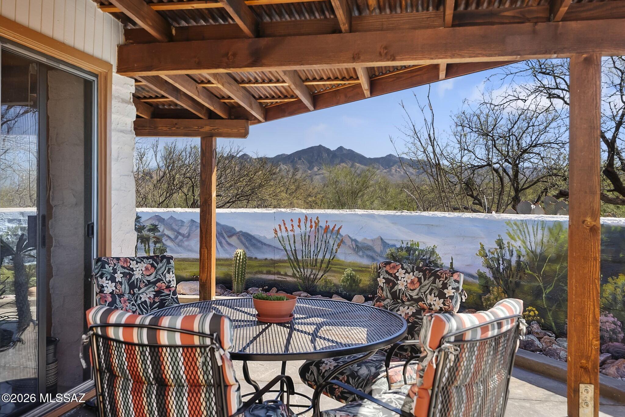 Nestled against a backdrop of sweeping Santa Rita Mountain vistas, this inviting desert retreat offers space, comfort and a spectacular natural setting. Relax knowing both HVAC systems with a transferrable warranty were replaced in 2021! With 2 bedrooms, 2 baths and 2 living areas, the home is thoughtfully laid out to maximize both privacy and flexibility for entertaining, relaxation, or a dedicated media room or hobby space. A bright and welcoming Arizona Room provides the perfect place to take in the landscape year-round. Expansive outdoor space (.82 acres) features walled courtyard, covered and open terraces, chicken pen and planting beds. Practical details include 2-bay garage plus additional carport for extra parking or storage. With beautiful views and versatile layout, this home captures the easy, relaxed lifestyle that makes Southern Arizona living so appealing.