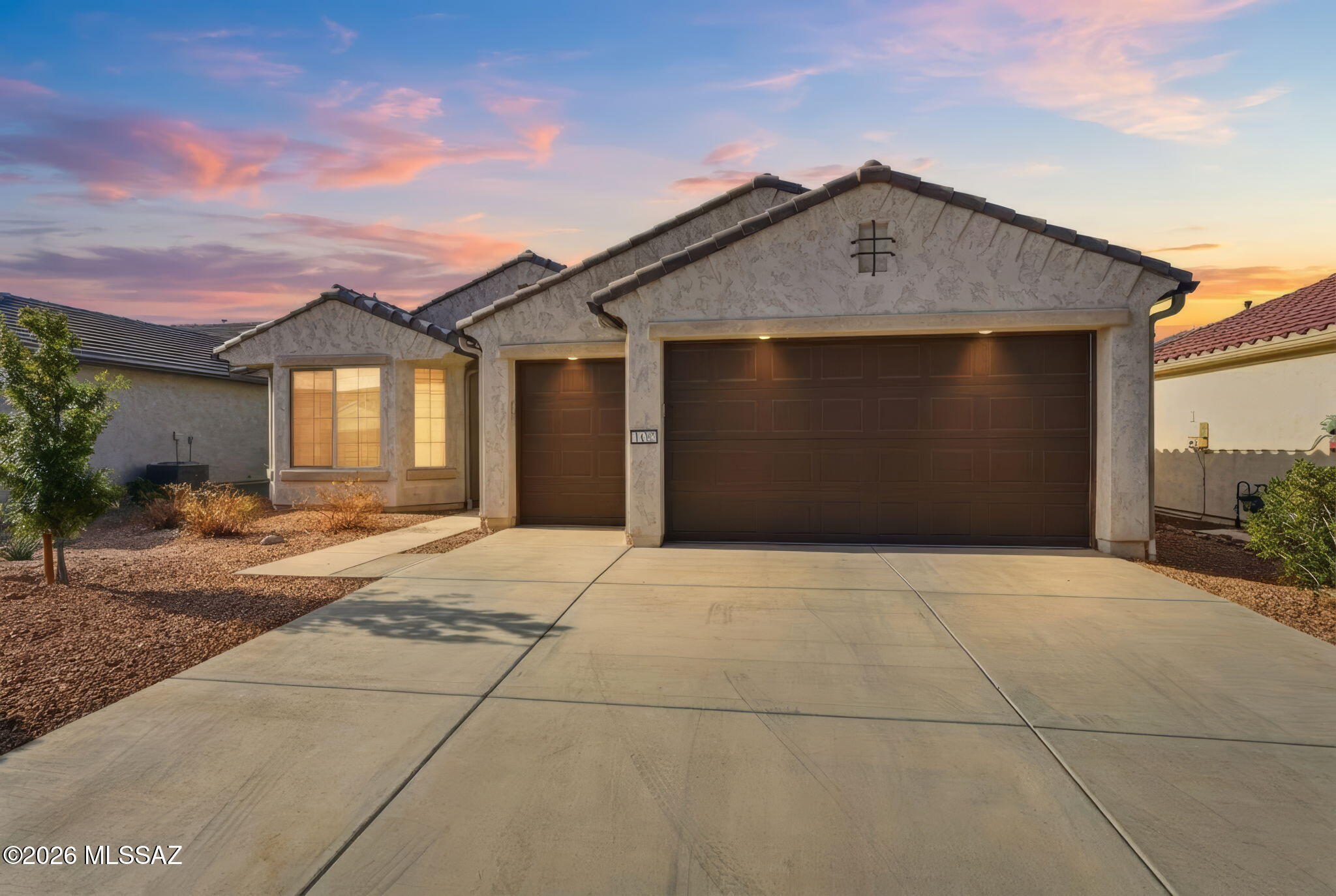 Fully furnished; all you need is your carry-on!! This home is located in the prestigious, gated 55+ community of Quail Creek. This beautifully appointed expanded Agave model offers 1,836 sq ft of thoughtfully designed living space on a premium lot with mountain views and no rear neighbor. The home features 2 bedrooms, 2.5 bathrooms, a two-car extended-length garage, plus a dedicated golf cart garage. Offered fully furnished (per separate inventory), the interior showcases ceramic tile plank flooring throughout the main living areas with carpet in the bedrooms, custom window treatments, and an inviting great room highlighted by an impressive 80'' electric fireplace with accent lighting, built-in storage cabinetry, and a mounted 75'' TV--perfect for relaxing or entertaining. The well-appointed kitchen features quartz countertops, stainless steel appliances, and a gas range, and it opens seamlessly to the living and dining areas. The laundry room includes a convenient folding counter and cabinets for added storage.
Enjoy outdoor living on the fully landscaped rear patio, featuring low-maintenance turf and retractable solar screens, ideal for year-round use. Additional upgrades include rain gutters, a whole-house water conditioning system, and a utility sink in the garage. This home offers comfort, style, and the exceptional resort-style amenities Quail Creek is known for, all in a prime location in Green Valley.