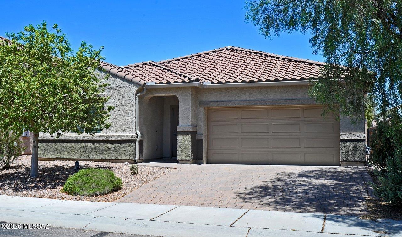 Welcome to your dream home in the highly sought-after master-planned community of Saguaro Bloom.  Built in 2017 by D.R. Horton, this immaculate 5-bedroom, 3-bathroom, 2,230 sq.ft. single-story residence perfectly blends modern luxury with effortless desert living.  From the moment you arrive, you'll appreciate the pristine curb appeal, highlighted by low-maintenance desert landscaping with mature trees, shrubs, and a beautiful paved brick driveway leading to a 2-car garage.  Step inside to a bright, airy open-concept layout featuring fresh, newly painted two-tone interior walls and elegant vaulted ceiling in the expansive great room.  The luxury chef's kitchen is an absolute showstopper, designed for both daily living and effortless entertaining. Abundant granite countertops privide endless workspace for meal prep.  The massive granite central island features plenty of room for stool seating and socializing.  The kitchen is equipped with a gas cooktop, stainless steel appliances, rich cabinetry, pantry closet, and a dedicated breakfast/dining space adjacent to the kitchen.  This thoughtful split-floor ensures everyone has their own space.  The 5 spacious bedrooms each have ceiling fans.  The primary bedroom has a large walk-in closet with extensive shelving, and the bathroom has a double vanity and shower.  The laundry room comes complete with a newer washer and dryer, plus built-in shelving for extra storage.  A pristine, newly painted 2-car garage houses an energy-efficient gas tankless water heater.  The low-maintenance desert backyard features a lovely covered back patio with north exposure perfect for relaxing.  As a resident of Saguaro Bloom, you'll enjoy resort-style community amenities just minutes from your front door that include a sparkling community pool, relaxing spa, a fun splash pad, clubhouse, and a start-of-the-art fitness area.  There are also numerous community parks, playgrounds, and miles of scenic walking trails nestled against beautiful desert backdrops.  This move-in home is conveniently located to local shopping, dining, and quick easy access to I-10.