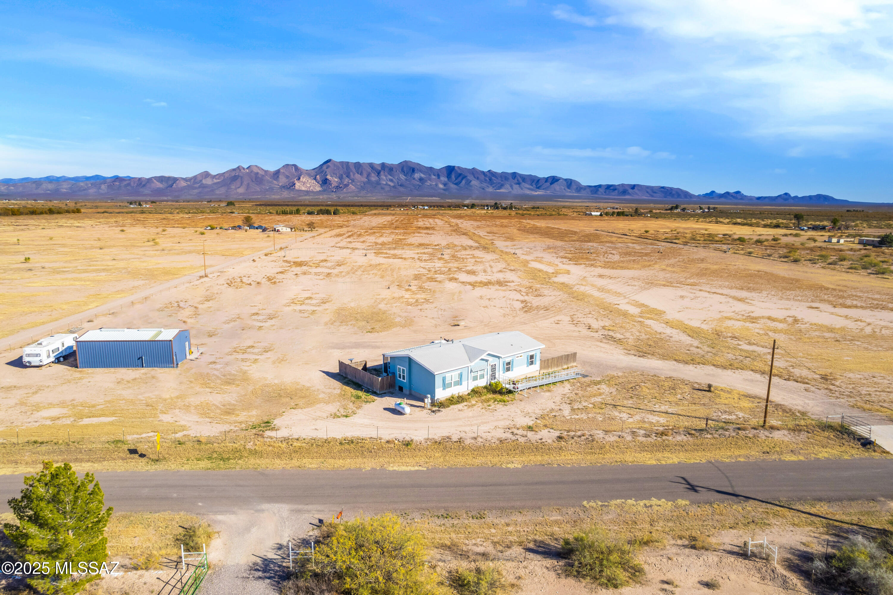 This incredible farm and home property offers the perfect blend of modern comfort and agricultural potential. The home is a gorgeous, newer (2018) manufactured home featuring laminate flooring throughout and charming farmhouse details. The kitchen is designed for both function and style, with a large walk-in pantry, spacious island, and stainless-steel farmhouse sink—perfect for everyday living or entertaining.
Additional interior highlights include a spacious laundry room with ample storage, a pellet stove, and a desirable split floor plan. Step outside to enjoy the impressive 12x37 enclosed and screened patio, ideal for relaxing and taking in the surrounding views. Home is connected to city water. Outside, the property features a 20x40 metal shop complete with 240 volt power, a hot water heater, and a convenient ½ bath, making it ideal for equipment storage, projects, or a working farm setup.
Beyond the home, this 79+ acre property is well-suited for agricultural use. Located within the Douglas AMA, the land includes 60 dedicated acres of water rights. While the property has not yet been farmed by the current owners they have set it up so that it can easily be put into production.

The farm includes mini pivot irrigation systems, designed for efficient water use. Currently in place are one full mini pivot and one half mini pivot. A ¾ mini pivot is also on the property and ready to be built, offering additional expansion potential.

In addition to city water, the property has three irrigation wells. One well is fully functional and ready for use and has been recently serviced with rebuilt and replaced components as needed, resulting in a system that functions like new. Updates include a Simflo pump, column pipe, tube and shaft, along with a natural gas Cummins NG engine, producing approximately 400 GPM. The well depth is approximately 650 feet. Two additional irrigation wells, each approximately 350 feet deep, are also located on the property and are not currently in use.

This is a rare opportunity to own a property with modern living, efficient irrigation infrastructure, and substantial water resourcesideal for agricultural, ranch, or investment use.