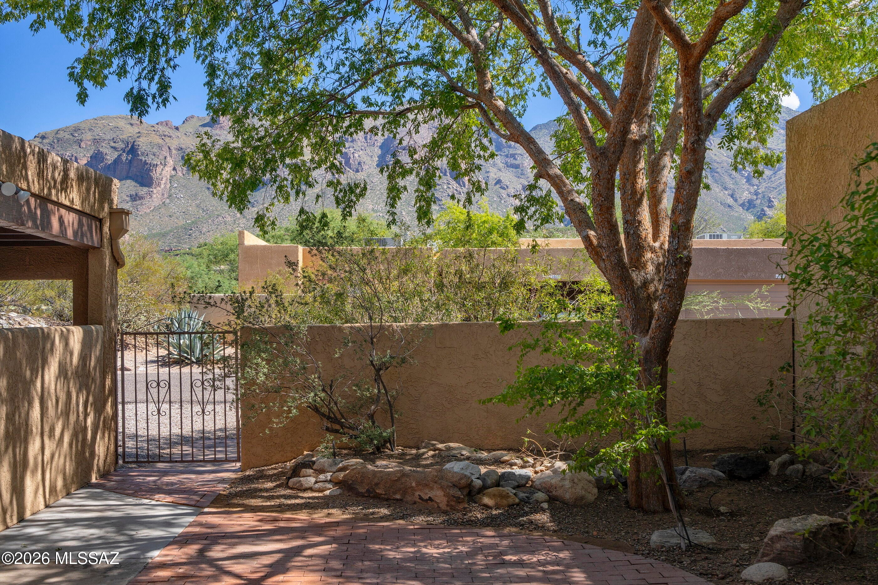Nestled in sought after Foothills TH community near La Encantada, this beautiful 3 BR, 2 BA townhome offers Catalina Mountain and city views along with great natural light throughout. Stunning ceramic tile flows throughout the entire home, creating a bright, clean, and inviting atmosphere. The kitchen features granite countertops and SS appliances, while the living room showcases a charming beehive fireplace-perfect for cozy evenings. Step outside to the front brick patio and take in breathtaking Catalina Mountain views. Enjoy mountain and sunset views from the living room. Residents also enjoy access to a community pool and spa. Offering the perfect place to relax and enjoy the Arizona lifestyle. An exceptional opportunity to experience foothills beauty and convenience
