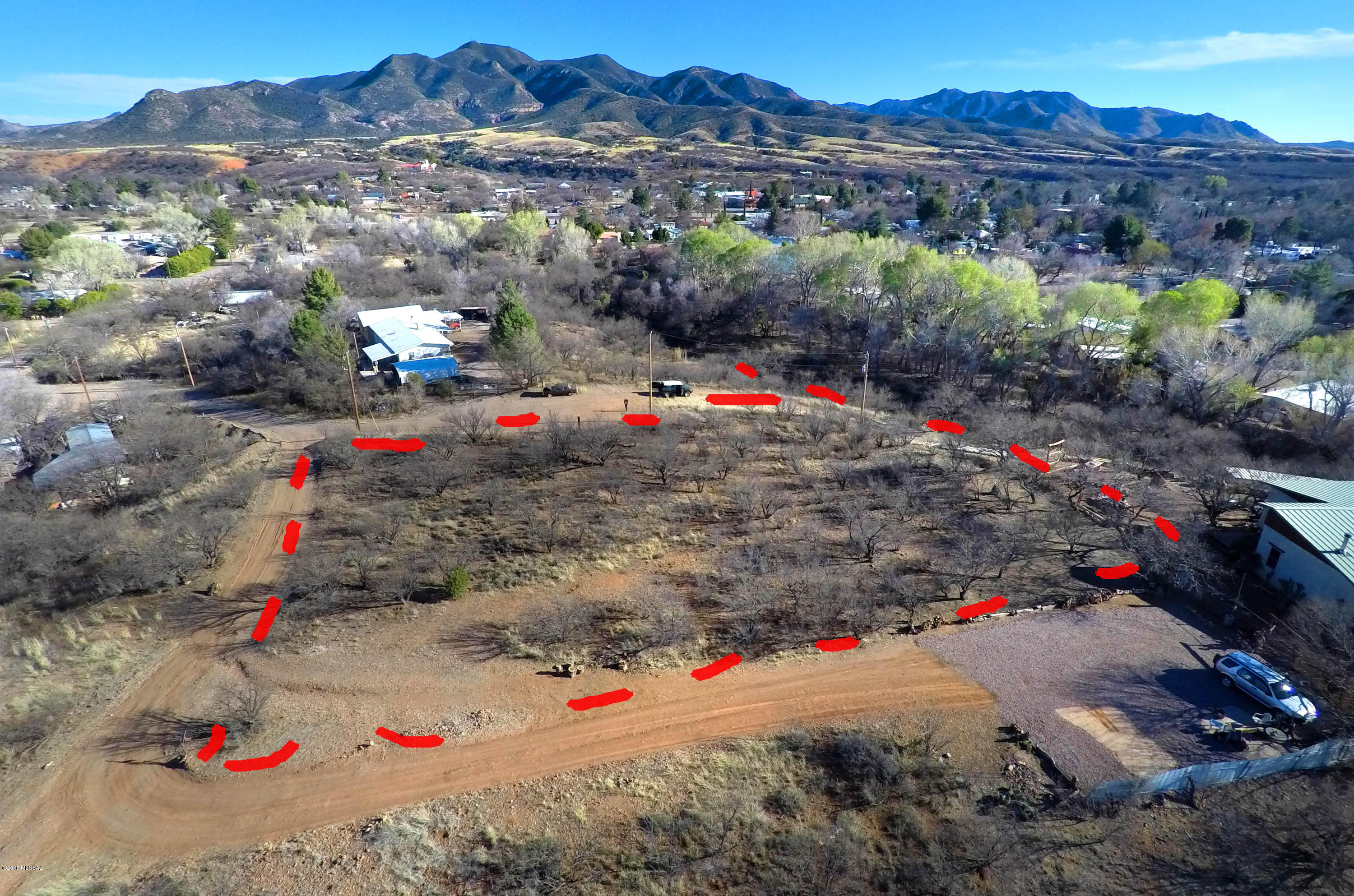 Technically the size of (4) Patagonia Town Lots, this higher elevation, gently sloping hilltop setting is a rare find. Given this center-of-Town hilltop setting, you're guaranteed 360 views of surrounding mountain ranges and hills (many of which are Coronado National Forest), as well as stunning sunrises and sunsets.  Of course, charming Patagonia village life is below.  Even seasonal Sonoita Creek is in view at the bottom of the hill (far below) but no chance of it ever flooding up here given how very far below the Creek is.  Situated just 3-4 short blocks from the heart of the village, it's an easy every-day walk to Patagonia Park and all Town conveniences and festivities if you choose to do so.  A septic system is needed here, as well as connection to the Town's Public Water System.