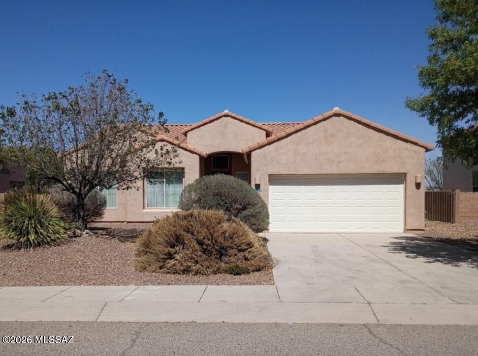 Located in the Bella Vista North subdivision of Rio Rico, this well-maintained 3-bedroom, 2-bath home offers high ceilings and an open floor plan with a cozy fireplace between the living room and kitchen. The spacious primary suite includes a large walk-in closet and private bath. This home was lightly used as a vacation home for the family, the property shows pride of ownership and is in excellent condition. Situated on a large lot with no neighbors to the rear, the east-facing backyard offers privacy and plenty of space to be able to create your own landscaping design. Additional features include central A/C, a 2-car garage, and convenient access to I-19 and nearby amenities.