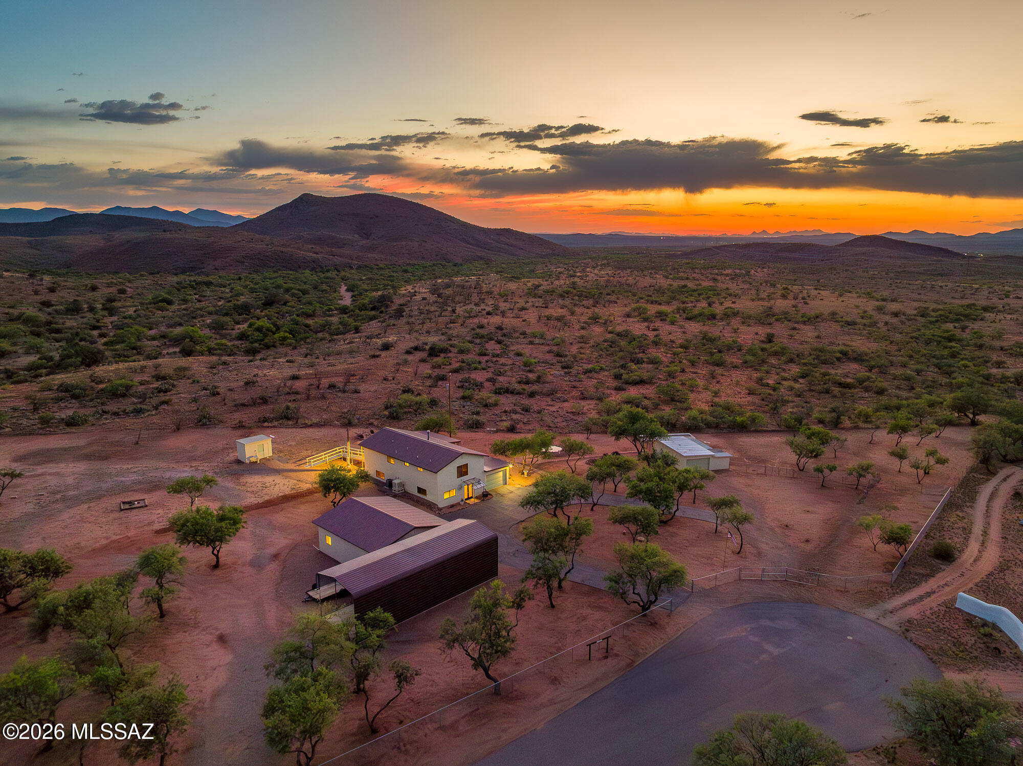 Stunning dual-living retreat on 2 fully fenced acres bordering state land, private well, 7 covered garage bays, RV carport, and a wildlife pond with deer and quail visiting daily. Less than an hour from Tucson. The 2,304 sq ft home features two complete living quarters, each with its own granite kitchen, private entrance, and independent access, ideal as an in-law suite, returning adult child, or supplemental income. Impeccably updated. Second parcel includes detached outbuilding with laundry, plumbed bathroom, and full RV hookups. That wildlife pond isn't a coincidence. Bordering state land creates a permanent wildlife corridor and guarantees nothing will ever be built behind you. Ever. New septic 2024. Metal roof 2019. Dozens of additional improvements throughout. No HOA. No flood insurance. Properties like this do not come available twice. Call today.