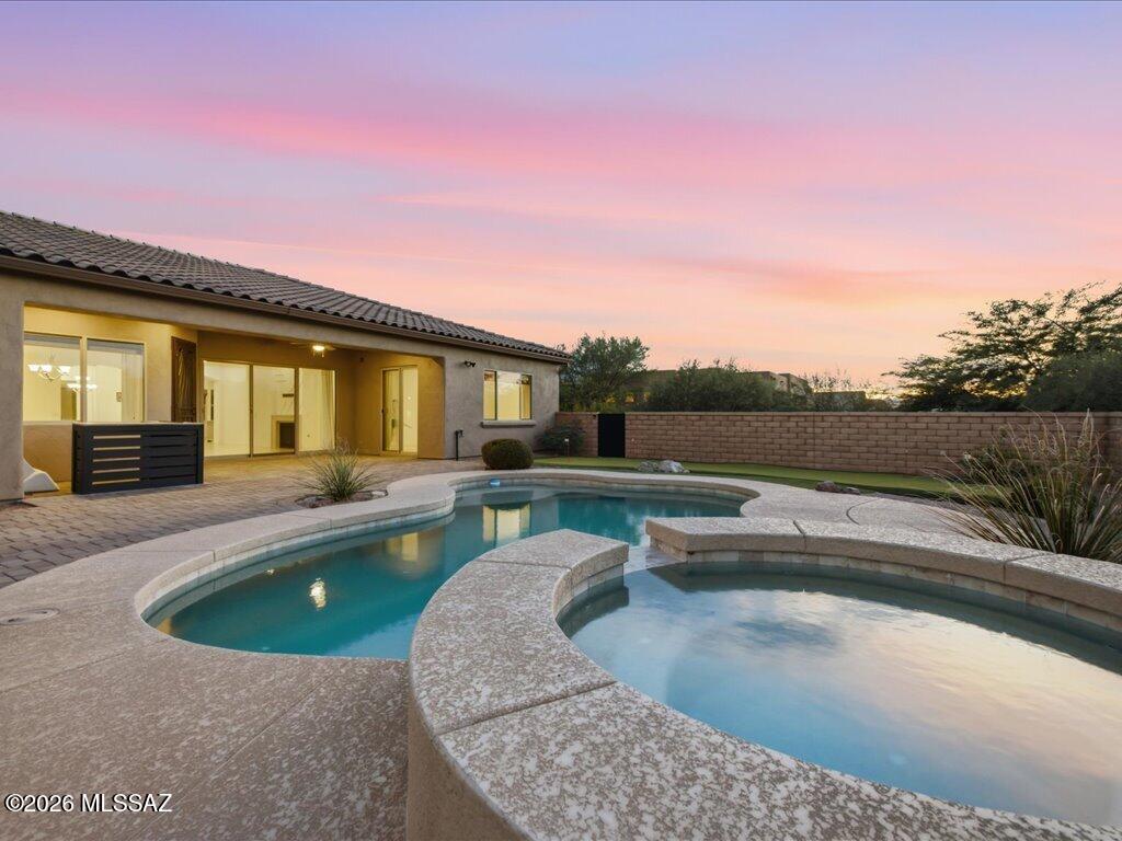 Set against the dramatic backdrop of the Santa Rita Mountains, this exceptional home in the gated Stone House community captures what Southern Arizona living is all about--space, privacy, mountain views and effortless indoor-outdoor living. Situated on approximately half an acre, the 2,893 sq. ft. this home offers 4 bedrooms, 2.5 baths and a thoughtfully designed open floor plan made for both everyday living and entertaining. At the heart of the home, a spacious kitchen with an oversized island, granite countertops, abundant cabinetry, built-in wine refrigerator and generous pantry opens seamlessly to the great room. multi-slide glass doors extend the living space outdoors and invite you to enjoy the Arizona lifestyle year-round. The backyard is its own private retreat with The backyard is its own private retreat with a heated pool and spa, putting green and covered paver patio--an ideal setting for quiet mornings, sunset cocktails or weekends spent entertaining.
A dedicated den takes advantage of Santa Rita Mountain views and offers extensive built-in cabinetry, while the oversized three-car garage provides room for vehicles, storage, bikes, a golf cart or workshop space and includes an EV charger.
Located within Stone House, one of the area's distinctive gated desert communities, the property is surrounded by the natural beauty of the Sonoran Desert and nearby mountain landscape. This isn't simply a home in Sahuarita--it's an opportunity to experience the space, scenery and relaxed desert lifestyle that make Southern Arizona so special.