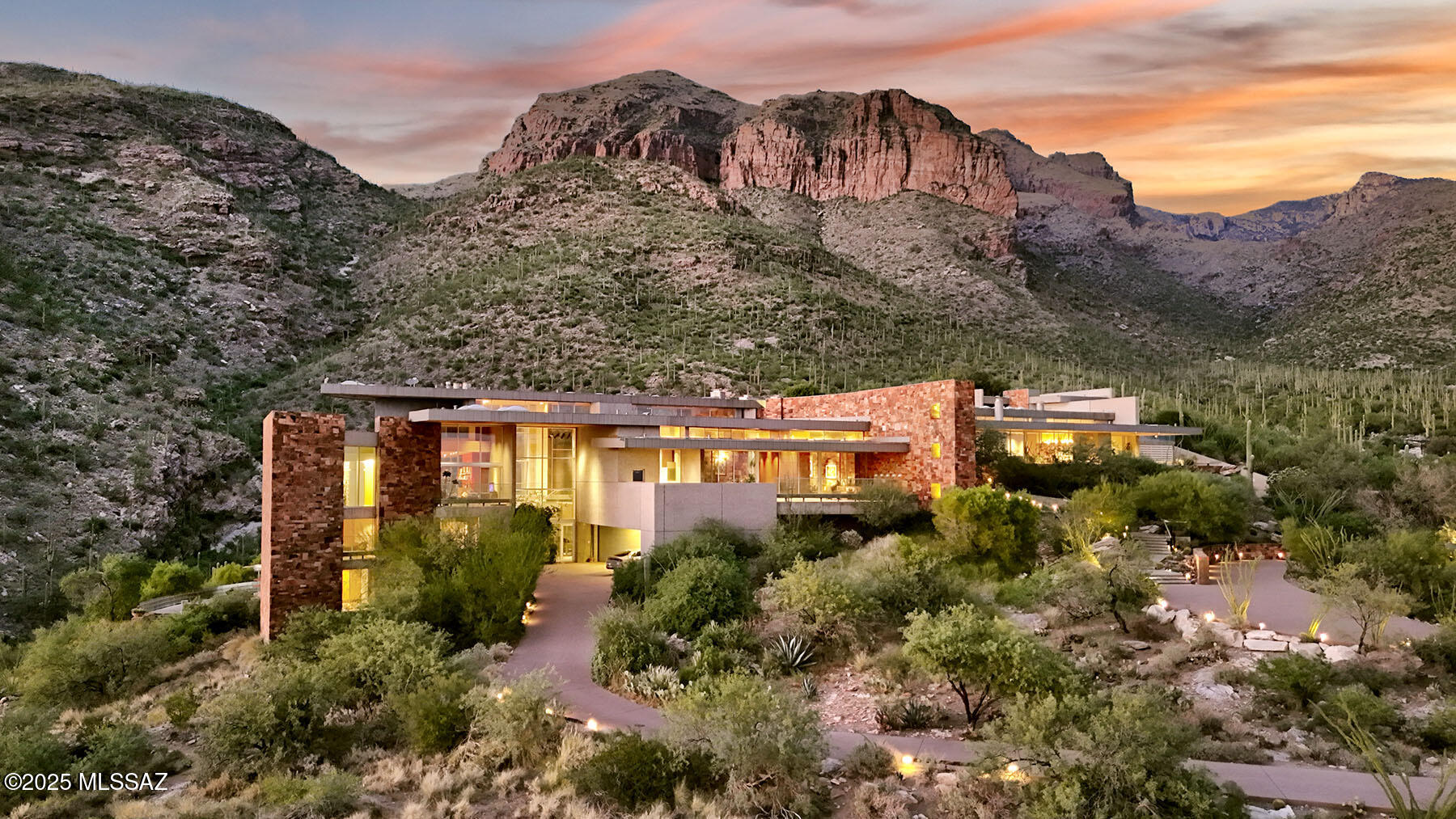Timeless architecture plus exceptional setting equals Campbell Cliffs. Sited on 6 plus acres of high Sonoran desert with over a million acres of protected national forest as your backyard. Main living areas all on one level approx 9000 sq ft primary bedroom/bath, entertainment room, living & dining rooms, kitchen & 2 offices, plus home theater.  Many other amenities: 3 Br/Ba guest level, 2400 sq ft guest/staff house, lower level 2000-bottle wine cellar, hobby room, workshop & Olympic sized gun/archery range. Healthy living with pool/spa, tennis court and 2-level gymnasium w/aerobic & weight machines, sauna, steam room, and rock climbing wall. Also offers security with 24-hour guard-gate & safety patrol. For more info & pictures visit campbellcliffs website.