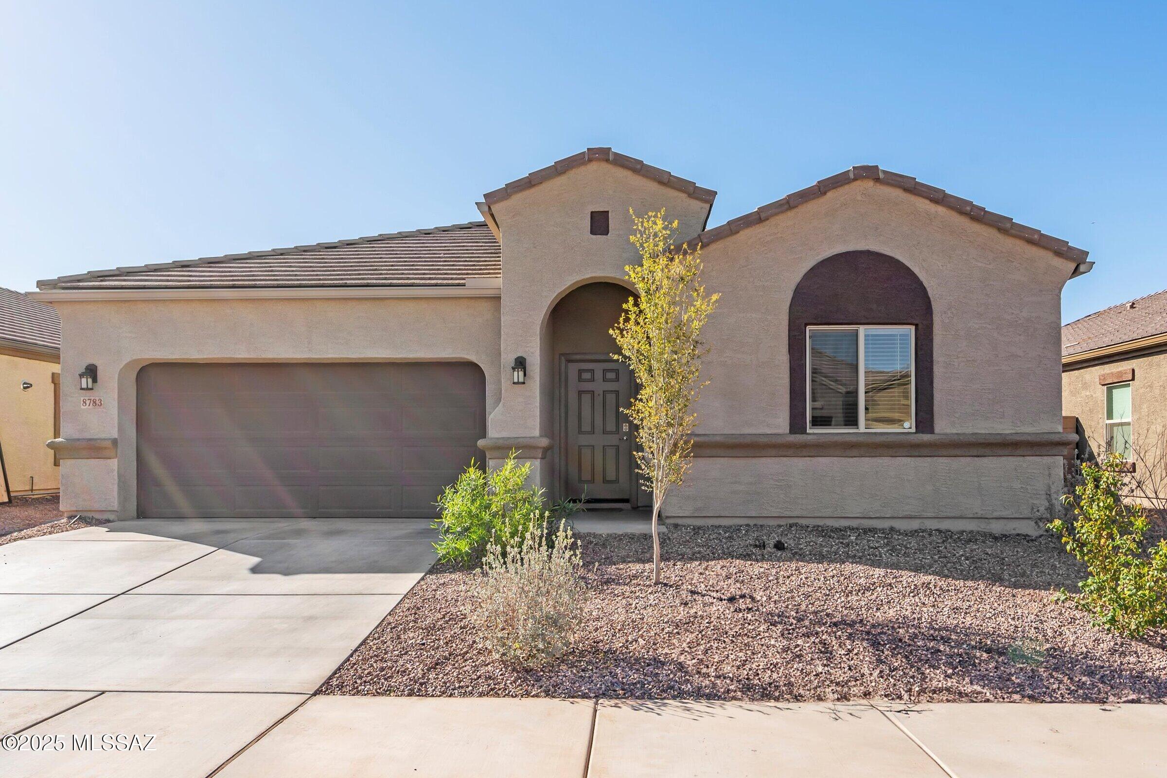 A rare opportunity! Assume the seller's LOW 4.99% interest rate and the opportunity to own  this stunning practically brand NEW home. The highly sought-after Prato floorplan - no longer available from the builder - offers 4 bed, 3 baths including a guest ensuite for added privacy & convenience PLUS a 3-car tandem garage. Designed for style & function, this home features elegant gray wood-look plank tile thru-out the main living areas.. The spacious great room is perfect for gatherings, while the kitchen offers abundant granite counter space for cooking & entertaining. The expansive primary suite is a true retreat, boasting a luxurious bath and oversized walk-in closet. PLUS amazing community amenities - multiple pools & parks, fitness room and party rec center. A must see! Backing to a scenic common area, enjoy gorgeous southerly views of Sombrero Peak from your own backyard. This home is truly a must-see. don't miss your chance to own this exceptional property! Schedule your private showing today!