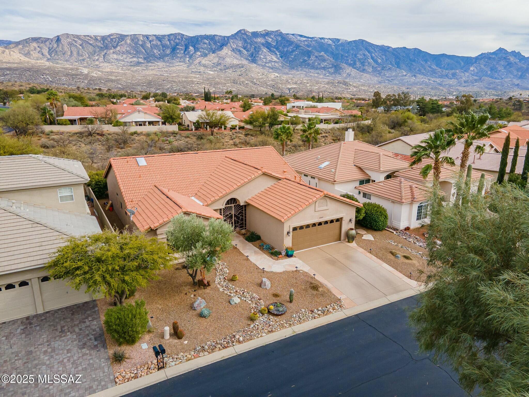 NEW ROOF completed by end of October. Wake up every morning to sunlight pouring in and breathtaking sunrises over the Catalina Mountains while you are enjoying your coffee.
This beautifully updated Estancia home.
Soaring 15 foot cathedral ceilings and walls of windows throughout the main living areas create an open, airy atmosphere and fill the home with natural light.  Luxury vinyl plank flooring, all new SS appliances, New baseboards, two custom floor to ceiling stone showers, two generous walk in closets,. Inviting secured iron screened in porch and enclosed backyard are welcoming to any pet. Updated fixtures, fans, faucets and hardware throughout add a fresh, modern touch. Move in ready!

Ideally located in a highly desirable HOA 1 area where IMPROVEMENTS 37547 S. CANYON SIDE DRIVE

-Remodeled floor plan 
-All new luxury engineered vinyl plank flooring
-New two custom showers with extended tile 
  and river rock floor
-All new baseboards 
-Accent wall paint
-Extended masonry wall back patio
-Barn door in guest bathroom 
-All new kitchen stainless steel appliances 
-Newer Washer/dryer
-Additional kitchen shelving and pantry closet
-New gas line and range
-Instant Hot water faucet 
-Farmhouse sink
-New fixtures, fans, faucets, hardware
-Epoxy driveway
-Flagstone Walkway
-Additional electrical added for additional fans
-New decorative rock, boulders, swail 
-Rescreened patio entrance and screening throughout 
-New cornices throughout 
-Copper backsplash
-Granite island
-New hot water heater 2022
-New garage door opener 2022
-Overhead garage storage unit added
-Landscape lighting 
-All interior doors painted
-Air ducts cleaned 2023
-GFI added on patio for fountain
-Only 10% of homes here share a fabulous mountain view


Advanced Features that make this home special: 
Make this your Home!

Only a small percentage of homes here have:

Expansive Mountain View from most rooms

Extremely vaulted 15 ft ceilings 

Extensive hardscape Flagstone front and back-no maintenance backyard

Entry foyer coat closet

Two Custom Walk-in Stone Showers

Remodeled floor plan, turnkey interior

Screened Porch

Convenient proximity to PT, Pharmacy, Dentist, Bank, Salon

Proximity to Main Clubhouse/fitness with Separate Men/Womens Hot tub, Sauna. . 

Immediately off Walking Path and Dog trail