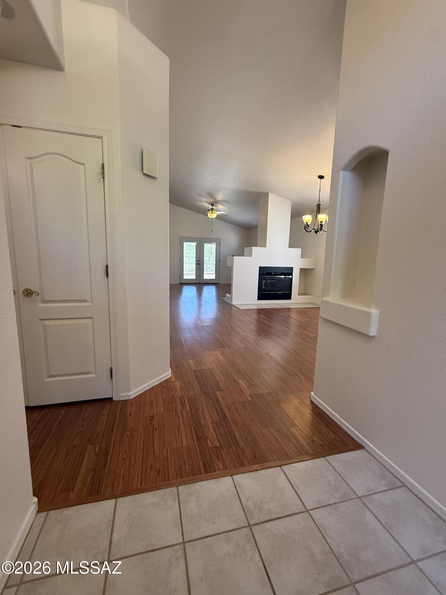 Clean, Bright 3 Bedroom Home in Rancho Vistoso. Move in Ready w/ stainless steel appliances. New French doors installed in living area & primary bedrooms w/ safety metal screens allows for fresh air filter and natural lighting throughout. Two way fireplace in living/dinning area. New tile flooring in primary bedroom, large walk in closet, carpet in two front rooms, large laundry room leads into garage which offers built in work bench with plenty of space to park. Water filtering system, New water heater and new A/C Unit. No back yard neighbors with gorgeous views. Extended patio with shade. Close to shopping & parks.