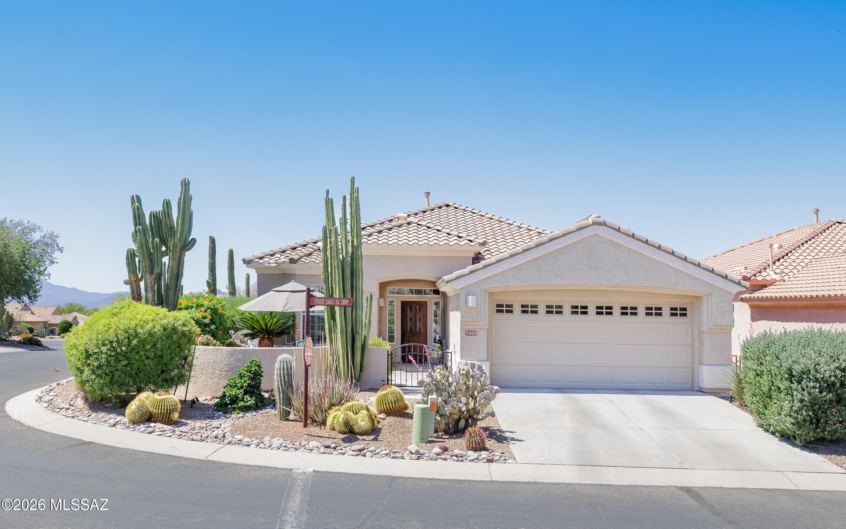 Seller will entertain offers between $400K-$448K. Highly popular Hillsboro model w/gorgeously landscaped grounds. Relax in the peaceful & relaxing front gated courtyard w/lovely mountain views. Backyard has extended flagstone patio & solar shades. HVAC replaced in 2017, hot water heater shortly afterwards. Home has 2 bay windows (both bedrooms), elegant plantation shutters, cozy gas fireplace in great room + fire pit on back patio. All stainless kitchen appliances & laundry (Speed Queen) appliances convey. High end new Bosch refrigerator awaits you!  Exterior has been painted within past few years. All patio flagstone freshly sealed Apr 2026, along w/newly epoxied garage floor also in Apr 2026.  Brand new carpet in both bedrooms. Seller fully fenced the back & side yards. Great for dogs! Front courtyard furniture and rear patio furniture plus gas grill are all available. Fencing was installed professionally by Affordable Fencing w/extra wide gates (@$6000 at time of installation). This home has outstanding curbside appeal - very tranquil/peaceful location. Tile flooring throughout except the 2 newly carpeted bedrooms (also another $6000 installation cost).  Home is move in ready.