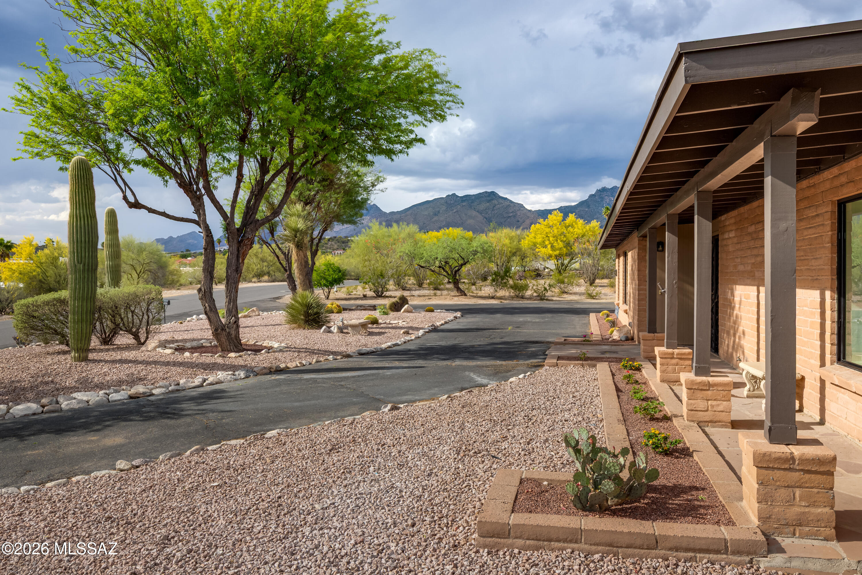 Completely rebuilt from the studs up with rare RV garage/workshop on nearly ¾ acre lot. This home offers the benefits of newer construction in an established Catalina Foothills setting. 2,337sf, 4BR, 2½BA home has mountain views & modern finishes throughout. The renovation includes all-new electrical wiring, drywall, flooring, fixtures, hot water tank & HVAC duct work. Step into bright, open living spaces designed for comfort & flexibility. Kitchen features fresh cabinetry, quartz counters & seamless flow to the main living area. Formal Living/Dining areas. Open to the kitchen, the Family Room has corner fireplace and glass door to covered patio. Primary suite offers a sleek new bath. Three additional bedrooms support guests, family or office needs. Outdoors, enjoy a newly plastered pool and spa surrounded by natural desert landscape and easy-care artificial turf in a fully-enclosed backyard. A rare find, the 1,122sf RV garage/workshop is perfect for hobbyists, collectors, trades, or desert toys. Located minutes to Sabino Canyon, La Encantada, Whole Foods and casual to upscale dining. The University of Arizona and downtown are within easy reach. 2 year contractor warranty. No HOA