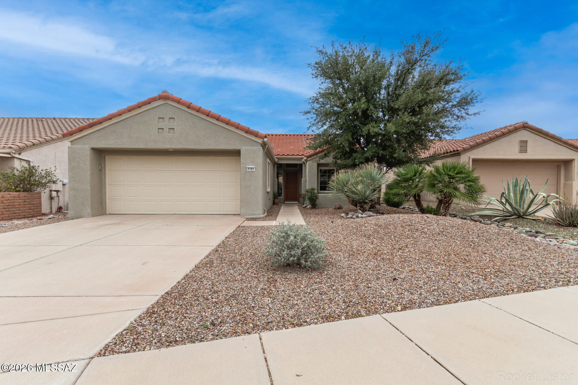 MOVE-IN READY! Experience refined, resort-style living in the highly coveted active adult community of Sun City, where each day unfolds with a seamless blend of leisure, elegance, and vibrant lifestyle amenities. Including: Aquatic & Fitness Center, Artisan Center, a Bistro, Bocce Courts, Gift Shop, The Views Golf Club, Library, Mini Golf Course, Pickleball & Tennis, Picnic Area, The Views Restaurant, a large Activity Center, an artist's haven at Catalina Vista, two community centers Copper Center and Desert Oasis. And to manage it all there is a beautiful Welcome and Administration Center. 

This beautifully updated home features 2-bedrooms, 2-bathrooms, and an extended 2-car garage with built-in cabinetry. From the moment you arrive, the home captivates with its inviting curb appeal--featuring thoughtfully designed, low-maintenance landscaping, mature trees, and a charming walkway that leads to a covered front porch, perfect for enjoying peaceful mornings or welcoming guests in style.

Step into the gorgeous living space where thoughtful design meets effortless sophistication. From the moment you enter, you're welcomed by a sun-drenched living room adorned with elegant tile flooring, recessed lighting, a contemporary neutral palette, high ceilings, and stylish fixtures-perfect for both relaxed everyday living and effortless entertaining.

At the heart of the home, the chef's kitchen showcases stainless-steel appliances, lots of white cabinetry with crown molding, a spacious pantry, and striking quartz countertops, all complemented by a sleek breakfast bar perfect for both casual dining and entertaining friends and family. 

The large primary bedroom offers a private retreat, featuring direct access to the outdoor patio through sliding glass doors, a spa-inspired ensuite bathroom with a single sink with a side vanity, a elegant tile shower, and a generous walk-in closet designed for optimal organization. The second bedroom is ample size and shares the hallway bathroom that includes a jetted tub/shower combo. 

Enhancing everyday convenience, the laundry room is located inside- a washer and dryer are thoughtfully included.
Outdoors, the inviting backyard presents a covered patio--an ideal setting for outside dining, intimate gatherings, or simply relaxing beneath Arizona's picturesque skies with views of the Catalina Mountains. 

Impeccably maintained and truly move-in ready, this exceptional home offers a rare blend of comfort, style, and modern luxury. Don't miss the opportunity to make it yours!

Updates completed in 2021 include a kitchen remodel, renovation of both bathrooms, installation of tile flooring throughout, and complete exterior/interior repainting. The primary bedroom sliding glass door with patio awning was also replaced in 2021.

Buyers considering a purchase, there is a complimentary tour given of all the different community facilities/amenities via golf cart. Just head to the main office M-F before 3:00pm.