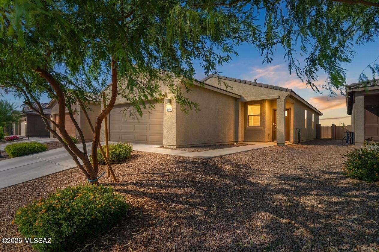 Immaculate, ENERGY STAR® certified, 2023-built single-story home with MOUNTAIN VIEWS in Valencia Crossing! This one-owner, move-in-ready 4-bedroom, 2-bath home offers 1,562 SQFT of open-concept living featuring granite countertops, abundant cabinetry, a large island with breakfast bar, high ceilings, stone-look tile flooring, warm carpets in the bedrooms, spacious walk-in closets. Premier builder upgrades include spray foam insulation, a tankless water heater, smart thermostat,  Includes Low-E windows, LED lighting, video doorbell, smart locks, irrigation, & a 2-car garage. Enjoy the community park, direct access to The Loop walking, jogging, and biking trail, plus a convenient location near I-10, Davis-Monthan AFB, and Tucson International Airport. Shows like a model, schedule your private tour today!