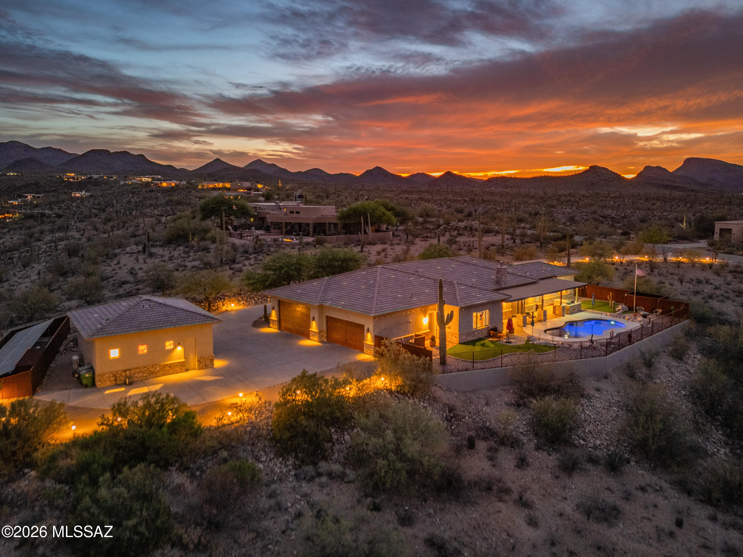 Perched high in the sought-after Tucson Mountain Reserve on the west side of Tucson on over 3 acres, this 3,348 sq ft estate delivers a lifestyle you feel the moment you arrive. Wake up to panoramic views of 5 mountain ranges, then unwind as city lights glow beneath a star-filled sky. Inside, a warm living room with a gas fireplace flows into a chef's kitchen with granite counters, gas range, ice machine, & a spacious walk-in pantry which is perfect for hosting. Seamless indoor-outdoor living opens to your private backyard with a pool, outdoor kitchen, and endless desert sunsets. Outfitted with Bulldog security doors, 2 tankless water heaters, owned solar, plus 4 bedrooms, 3 baths, & a rare 6-car garage with lift and urinal, this home offers space, privacy, & an unmatched Tucson lifestyle.