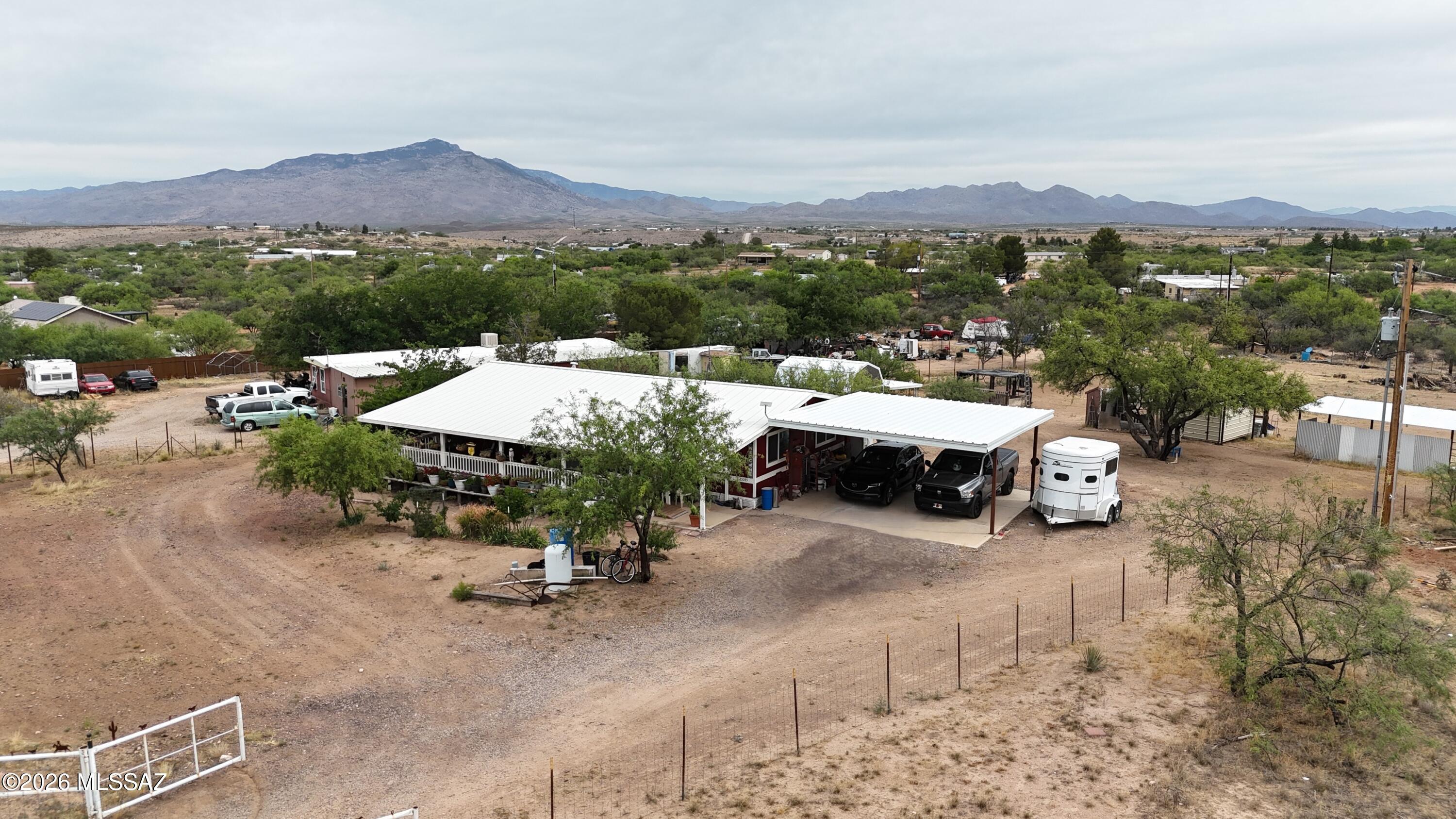 Enjoy peaceful country living with wide-open skies and beautiful mountain views at 25345 E. Comanche Trail in Benson, Arizona. This charming manufactured home offers 3 bedrooms, 2 bathrooms, and approximately 1,248 square feet of comfortable living space on over 1 acre of horse property. The home features a spacious covered porch perfect for relaxing and enjoying the surrounding desert landscape, along with a private well, and paved road access for added convenience. The property is fully suited for rural living with room for horses, animals, RV's, trailers, or additional outdoor projects. Conveniently located with easy access to I-10, this property combines quiet country living with a manageable commute to Benson, Tucson, and surrounding areas.