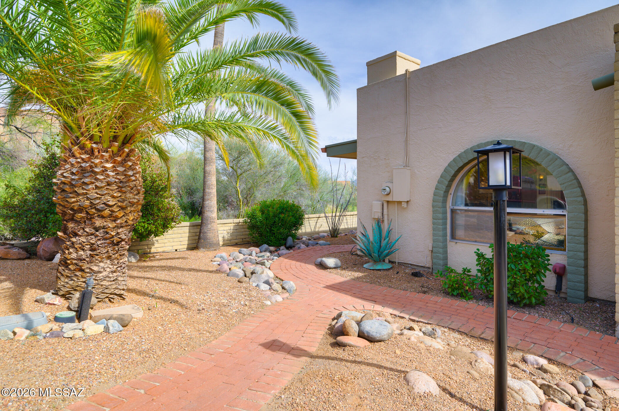 This well-maintained home offers 2 BR's, 2 Baths, and a den open to the great room, creating a comfortable and functional living space with an easy flow.  The upgraded kitchen is a true centerpiece by providing ample cabinets and counter space for the resident chef, plus a lovely kitchen island with seating.  An attrium brings in natural light and adds charm to the home's interior.  The AZ room adds flexible space for relaxing or hobbies.  Enjoy the spacious, covered patio overlooking a nuatural wildlife corridor with mountain views in a quiet, private, and peaceful seeting to soak up the beauty of the desert landscape.  Additional features include a separate laundry room, storage shed, and a 2-car garage.  Use as either a winter retreat or a full-time residence.  It is not to be missed!