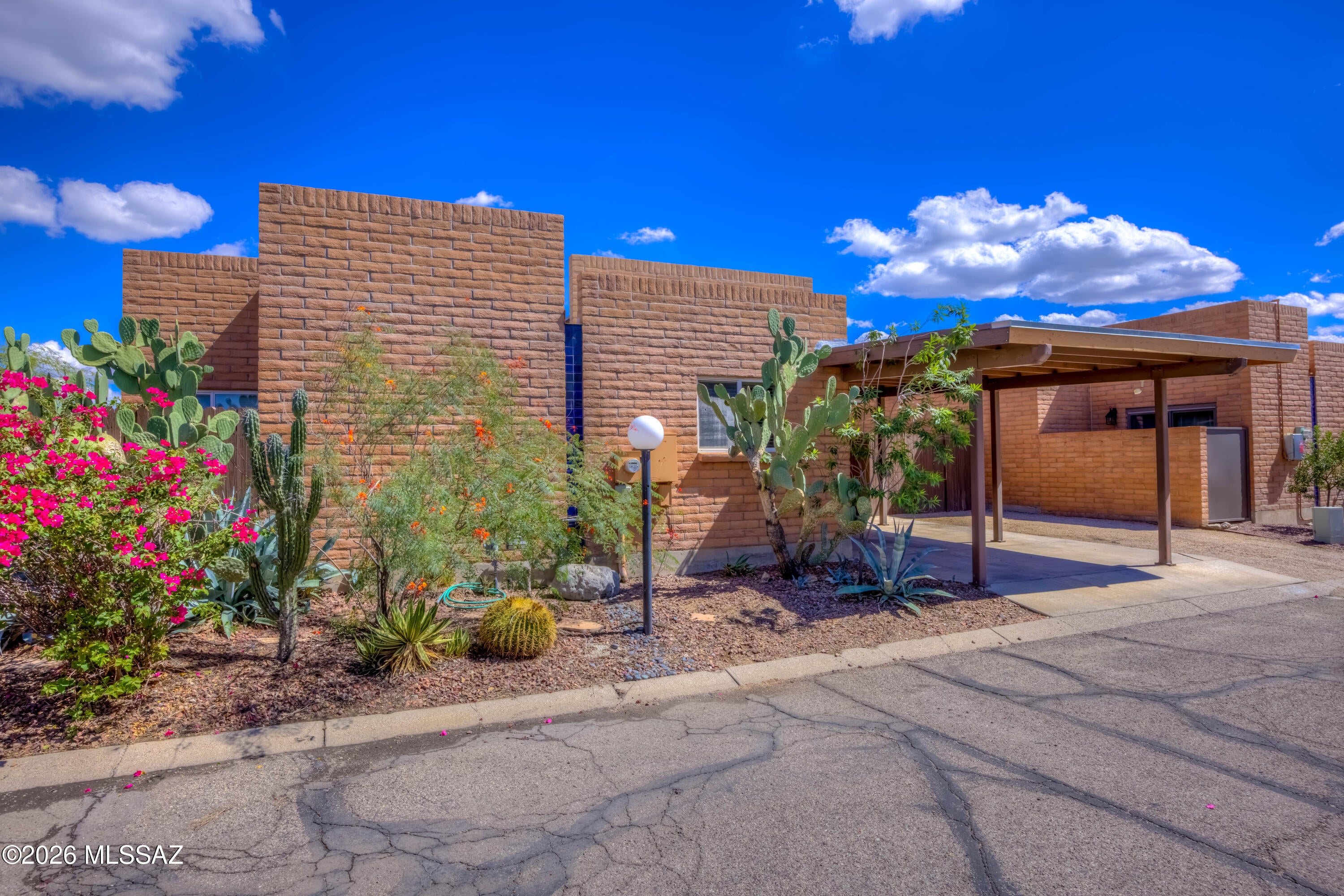 Beautifully upgraded Central Tucson townhome with stylish finishes throughout! This move-in ready home features Carrara marble countertops and backsplash, soft-close cabinetry, and stainless steel appliances. Soaring ceilings and clerestory windows fill the living and dining areas with natural light. Updated bathrooms offer granite countertops and tiled showers. Enjoy the private backyard with a covered pergola patio. Exterior storage room provides convenient additional space. The community pool is just steps away! Conveniently located minutes from the University of Arizona, shopping, dining, and entertainment. Don't miss this opportunity!