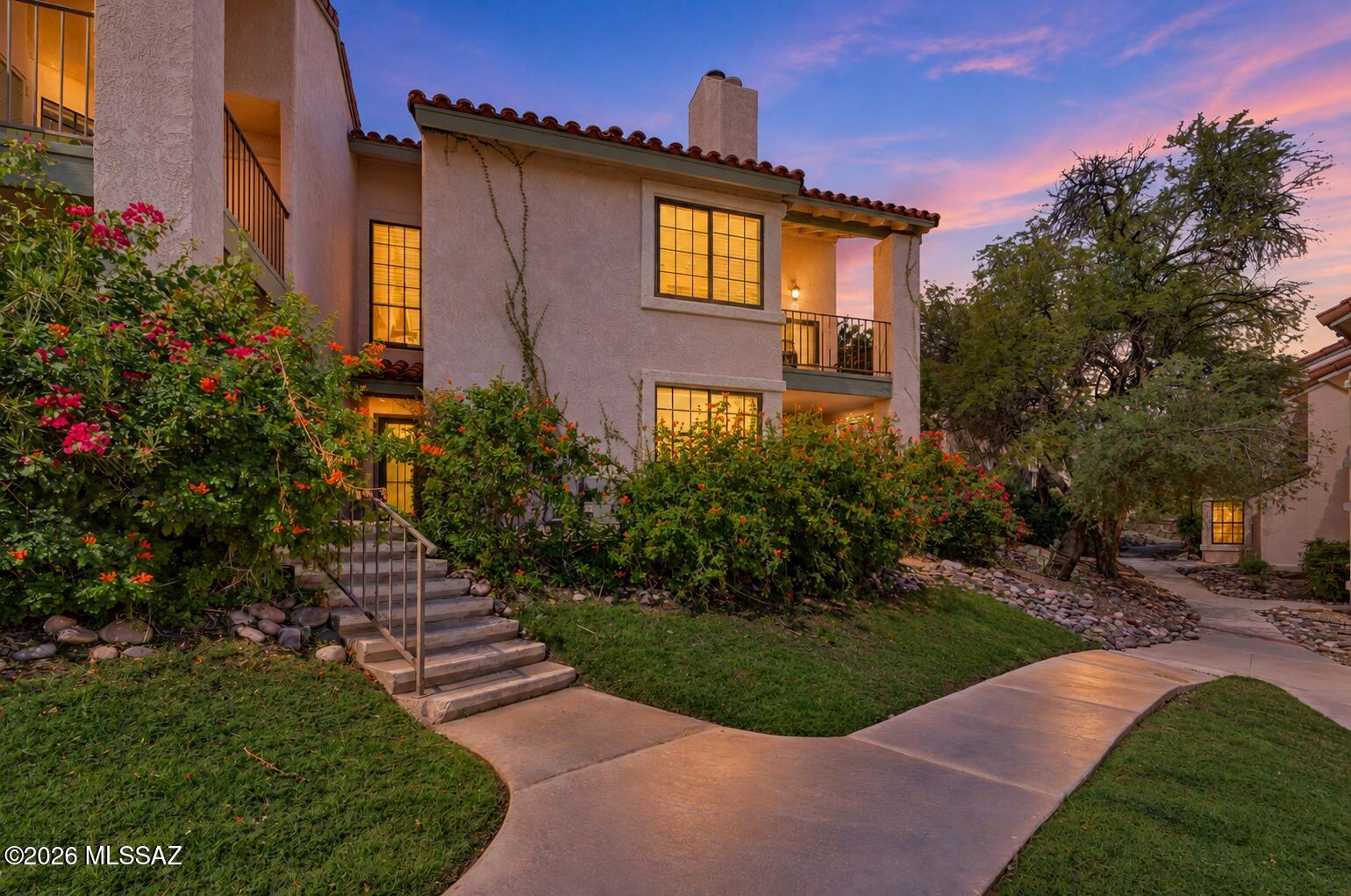 Foothills living with a view of mountains, greenery, and a world of conveniences nearby. Tucked within Tierra Catalina Condos, this two-bedroom, two-bath condo features a well-designed interior setting overlooking a lush common area with mature trees. A spacious living room with a fireplace opens to an expansive covered corner patio, creating an inviting connection between indoor comfort and outdoor relaxation. The kitchen brings together stainless steel appliances, an abundance of cabinets, and a breakfast bar, while generous bedrooms with walk-in closets provide room to settle in. The appeal extends well beyond the home: a heated pool and spa, tennis and pickleball courts, fitness center, and barbecue areas make recreation part of the everyday. Browse the boutiques at nearby La Encantada, meet friends for dinner along the Skyline and Campbell corridor, or explore the trails of the Catalina Foothills. With shopping, dining, golf, and resort destinations close by, this is a beautifully situated home base for enjoying Tucson. HOA provides all exterior maintenance, including roof for lock and leave convenience. Short Term Rentals allowed - no minimum day count.