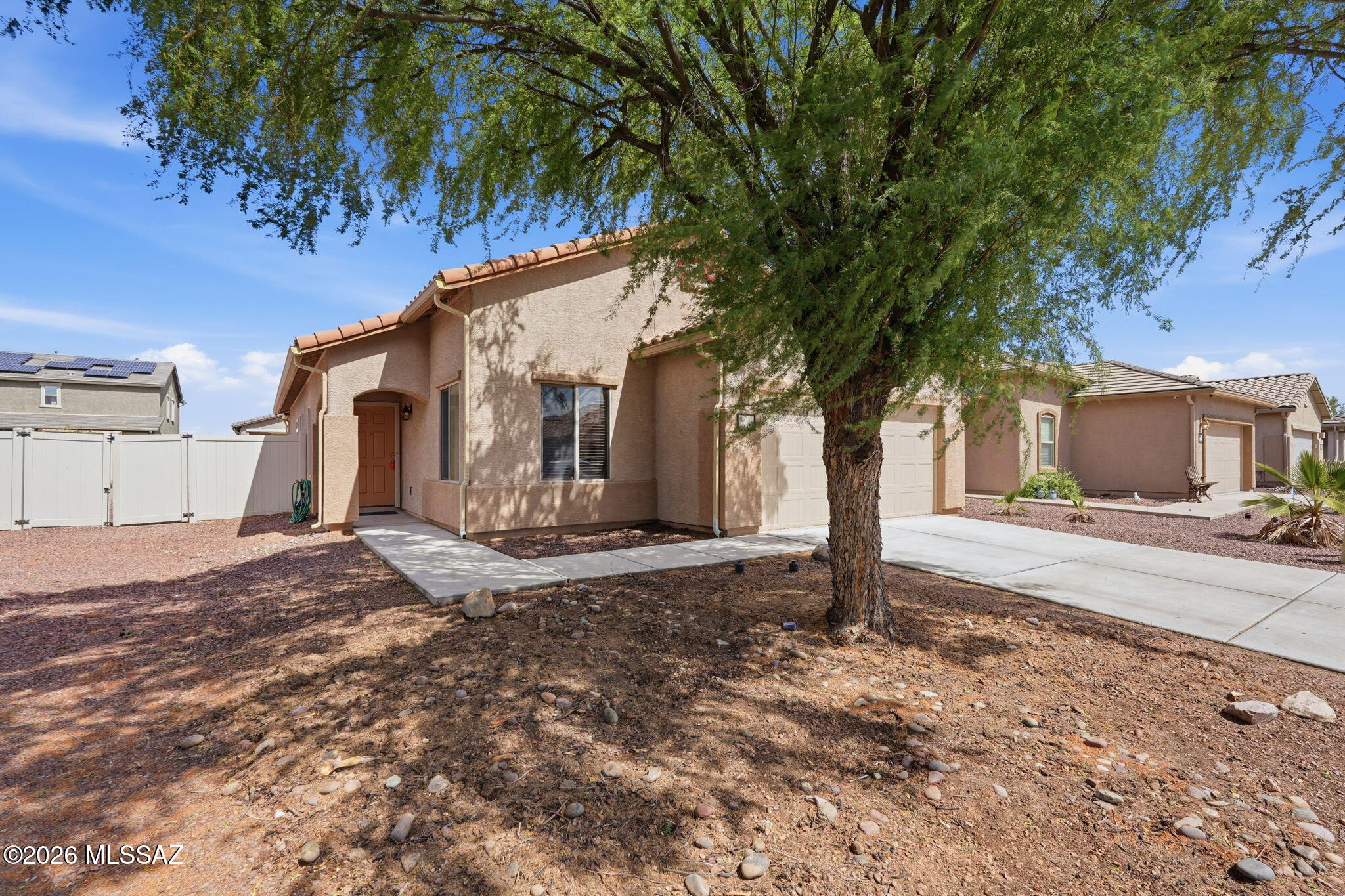 Welcome to this beautifully maintained 4-bedroom, 2 bath home in Red Rock Village! Built in 2007, this single story residence offers 1,776 sq ft of comfortable living with a spacious layout with extra storage, including two primary closets and two convenient hall closets. The kitchen features stainless appliances, pantry cabinets, and breakfast nook.  The open living and dining areas create a warm, inviting flow. Enjoy low-care landscaping front and back, a covered patio, and a two-car garage.  Located on a quiet, paved street near community parks and pool, this home combines modern convenience with small-town charm--perfect for relaxed Arizona living.
