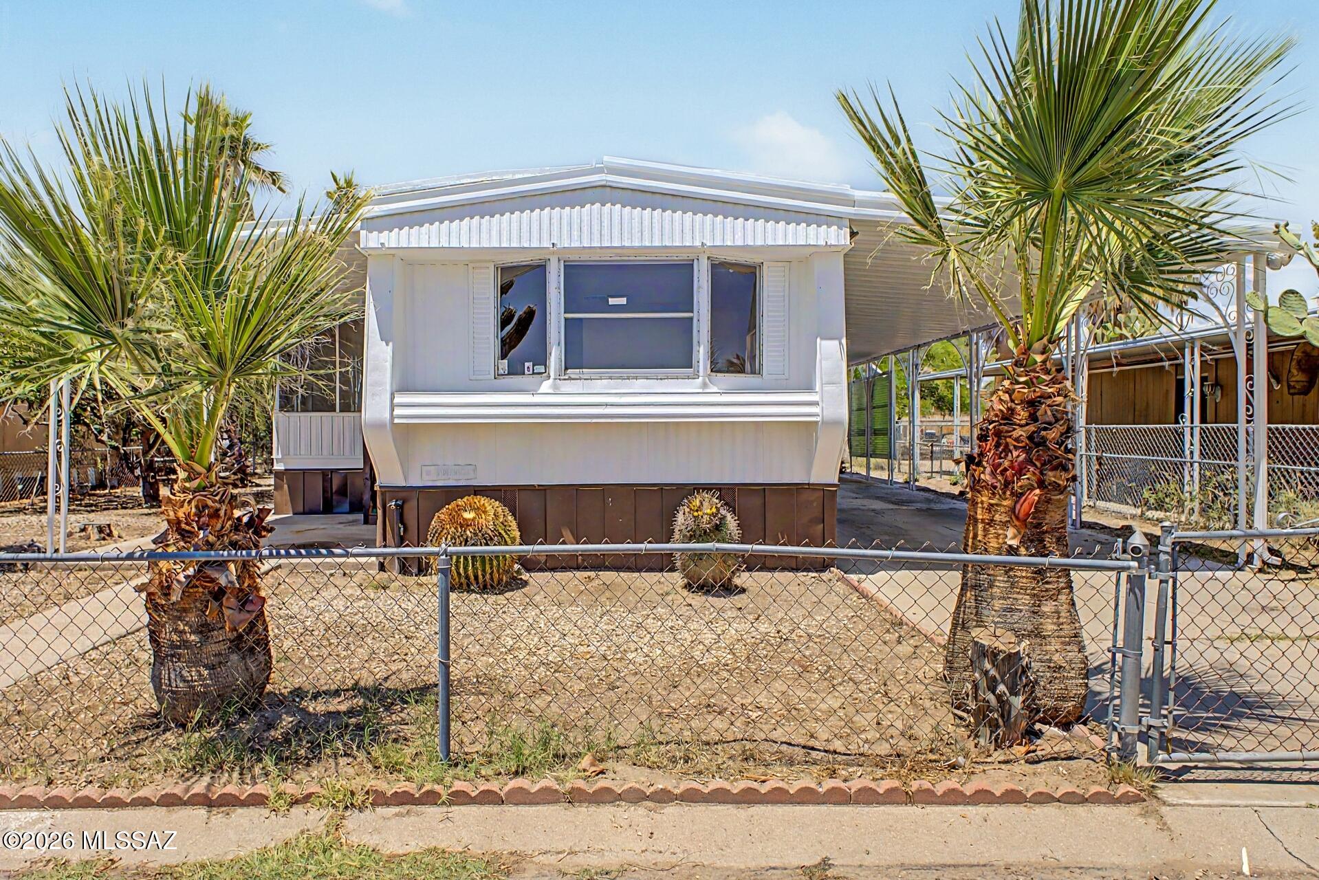 Welcome to this charming manufactured home! This gem features convenient carport parking and a cozy covered patio. Fall in love with the spacious living areas filled with natural light, perfect for entertaining and comfortable everyday living, showcasing wood-look floors and a soothing palette that makes every area feel warm and welcoming. The kitchen features spacious counters, ready for your choice of appliances. You'll love the two sizable carpeted bedrooms, providing ample space for relaxation. The screened-in patio is perfect for enjoying your morning brew and spending relaxing evenings. Out back, you'll have an easy-care landscape and storage sheds for extra organization. What are you waiting for? Come see it before it's gone! Agent/Owner