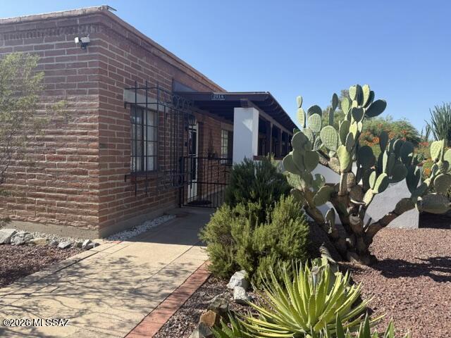 Enjoy carefree living located in the hub of Green Valley. This end unit features tiled floors, gas range, laundry shed with stacked washer and dryer(both approx. 1 year old), 2 closets in the primary bedroom, and covered back and front porches! The fully enclosed and gated front patio is surrounded by matures trees and plants. The community includes a pool and laundry facility.  Enjoy all the activiites, clubs and locations Green Valley Recreation offers.  HOA Statement in Documents tab.