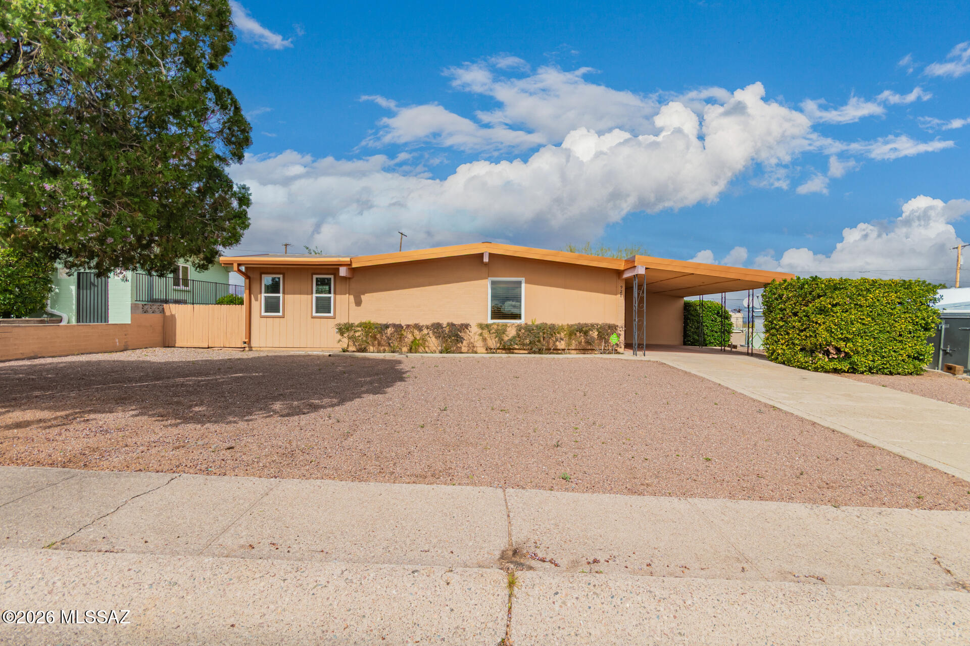 First time ever on MLS! Original owners, Original Del Webb Home. 2 bedroom, 2 bathroom home, with full size den/ office. This home has been well cared for, for generations! Featuring timeless finishes, along with recent modern upgrades including a durable steel roof, granite countertops, wood cabinets, plush carpet, tankless water heater and newer heating and cooling system for year-round comfort.  Enjoy added privacy with no rear neighbors and the convenience of a 50-amp RV hookup, and secure storage out back-perfect for travelers, part time residents or guests. A unique blend of original charm , functionality and thoughtful updates in a quiet setting.