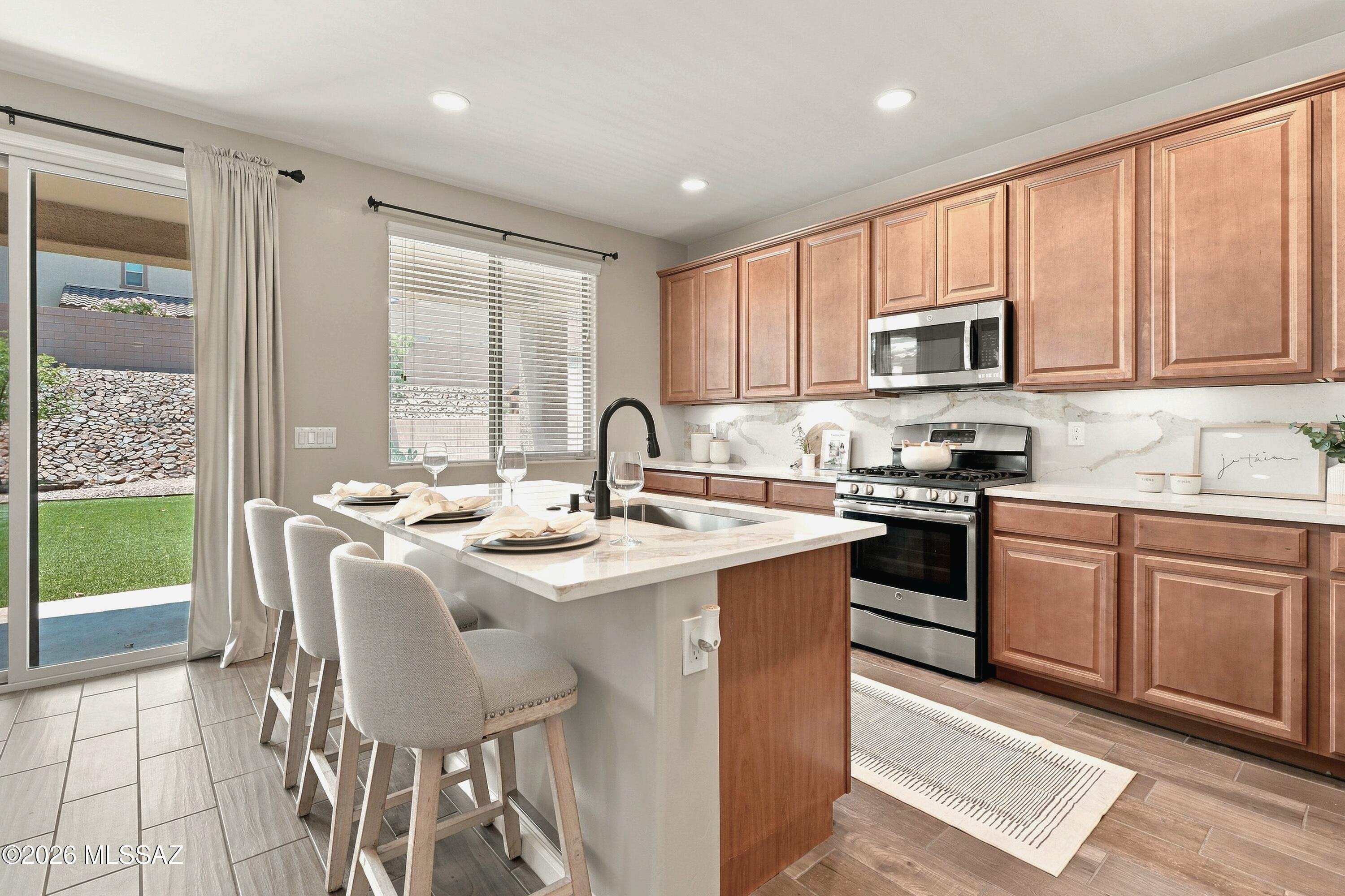 Move In. Unpack. Enjoy.

Redesigned for modern living, this home combines timeless style, carefully curated updates, and everyday functionality.

Offering nearly 2,600 square feet, five bedrooms, three full baths, and an enclosed loft that easily serves as a sixth bedroom, home office, media room, or playroom, this layout gives you the flexibility to grow, gather, work, and unwind--all under one roof.

Multiple living spaces offer endless possibilities, whether you envision a formal dining room, a second family room, a playroom, or a quiet retreat to relax.

A convenient downstairs bedroom and full bath provide the perfect setup for guests, multigenerational living, or a home gym. At the heart of the home, the beautifully updated kitchen blends timeless style with everyday ease. Designer quartz countertops, a full-height quartz backsplash, updated plumbing fixtures, and rechargeable under-cabinet LED lighting create a clean, modern aesthetic that's both elegant and inviting. An open-concept layout makes the space equally suited for busy mornings, family dinners, and effortless entertaining.

The expansive primary suite offers a peaceful retreat with a custom wood accent wall, designer barn door, and a beautifully remodeled spa-inspired bathroom featuring an oversized walk-in shower with a luxury rain shower head. Designer quartz continues throughout all three bathrooms, complemented by updated sinks, plumbing fixtures, lighting, and finishes that create a cohesive, elevated feel throughout the home.

Just as impressive are the thoughtful details that make everyday life easier: CAT-5 hardwired internet connections in every room, abundant electrical outlets for today's connected lifestyle, enhanced closet organization, clever under-stair storage, and a custom garage workbench with built-in shelving. These are the kinds of details you'll appreciate long after move-in day.

Step outside to a pool-sized backyard framed by mature trees, refreshed landscaping, new and improved irrigation, and a playhouse/yoga studio ready for your finishing touches. Covered front and back patios create inviting outdoor living spaces, perfect for morning coffee, entertaining friends, or simply enjoying Arizona's beautiful evenings.

Located in the highly sought-after Vail School District, you'll enjoy convenient & close access to I-10, Raytheon, Amazon, an ever-growing list of shops and dining, hospitals, the public library, and the future Southeast Regional Sports Complex--bringing convenience, community, and everyday amenities just minutes from home.

Some homes simply check the boxes. This one gives you more.

Owner/Agent.