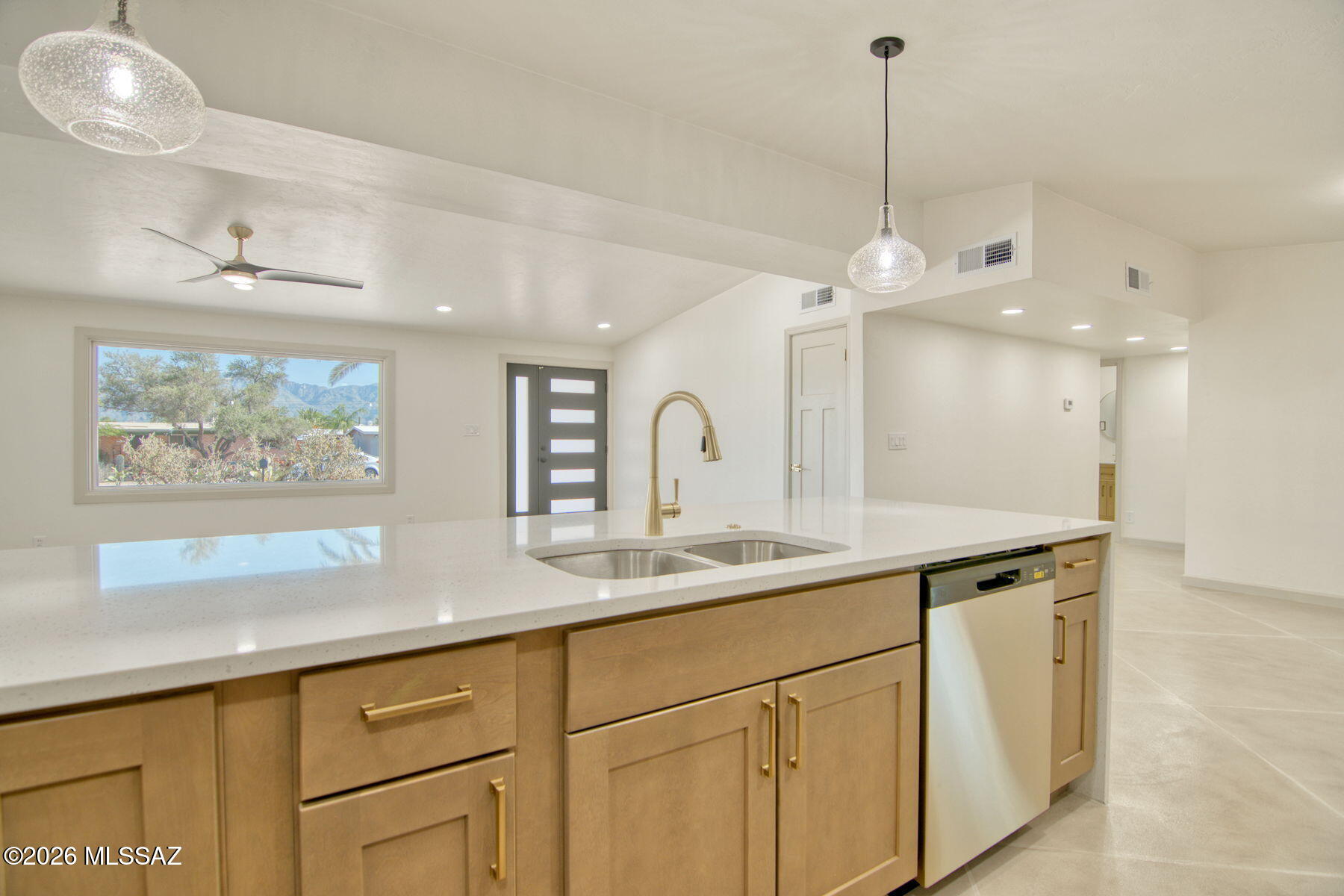 Range priced- Seller will entertain offers between $365,000 and  $385,000. Amazing remodeled home on Tucsons near eastside.  This home features 5 bdrm, 2 bth. Custom concrete floors, new windows, , new doors, recessed can lights, and super cool corner fireplace. Large .19 acre lot, great curb appeal with a circle drive and a hard to duplicate adobe brick construction. You will love the remodeled bathrooms,  and a rare to Tucson mudroom. Mountain views from the front and a quaint covered patio with mature trees. We saved the best for last with an open floor plan featuring an amazing kitchen with huge island and new SS appliances including a has stove and quartz counter tops. Owner/Agent